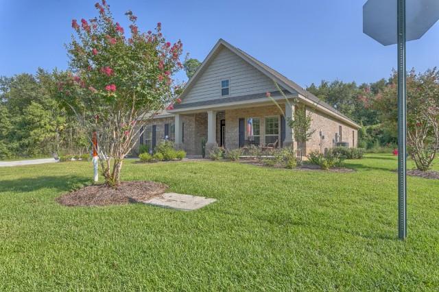 Welcome to Peach Creek! This home is ready for its first homeowner! New construction four-sided brick ranch style home with front porch. Home featuring grand entry and raised, tray ceilings leading to bright and open family room. Large Island in kitchen is perfect for Entertaining! Brand new GE appliances and Moen fixtures. Spacious Master bedroom with large walk-in closet! Master bathroom features dual vanities, shower and garden tub, with separate water and linen closet. Split floor plan and wooded back yard for additional privacy. Sodded and landscaped lawn with brand new irrigation system for low maintenance lawn care. *Pictures may be of similar, but not necessarily of subject property, including exterior and interior colors.