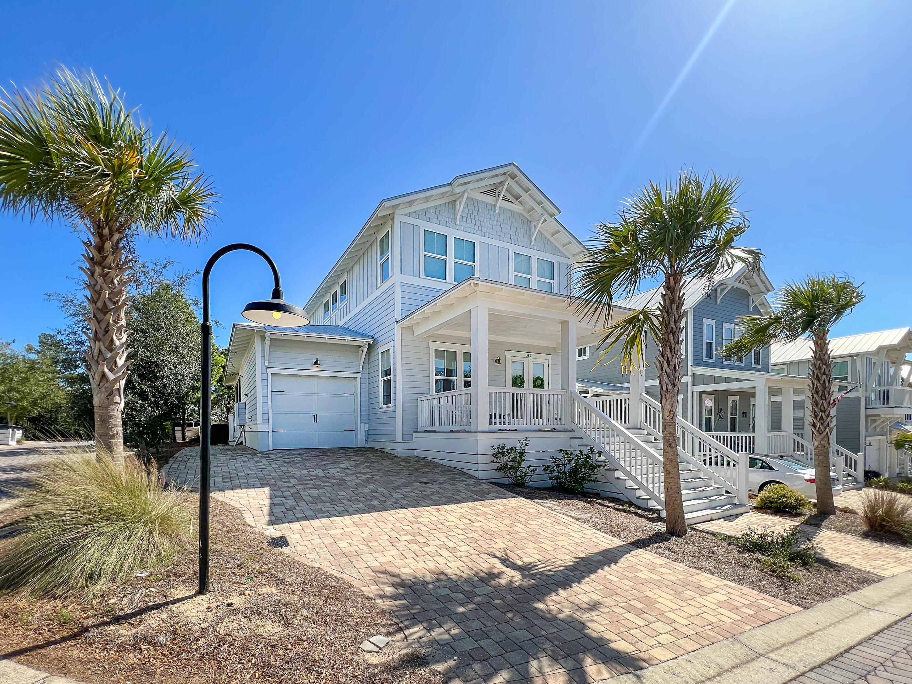 This beach house at Highland Parks on 30A is stunning! Located on the corner and with plentiful windows, the home gets washed in sunlight all day making it feel light and airy. The first floor features open main living areas, a gorgeous kitchen, as well as a spacious master suite. Upstairs you'll find a guest suite, two additional bedrooms, and a large hall bath. The stylish décor, furniture, shiplap walls, and wood floors give this home a chic coastal feel. Entertain your guests out on the screened patio or soak in the sea breeze on the large front porch. Take the nearby trail to the expansive pool area that features beautiful stone accents, fountains, fire pit, outdoor kitchen, and more! Beach days are easy since you're about a mile from the Blue Mountain Beach Access. Paradise!