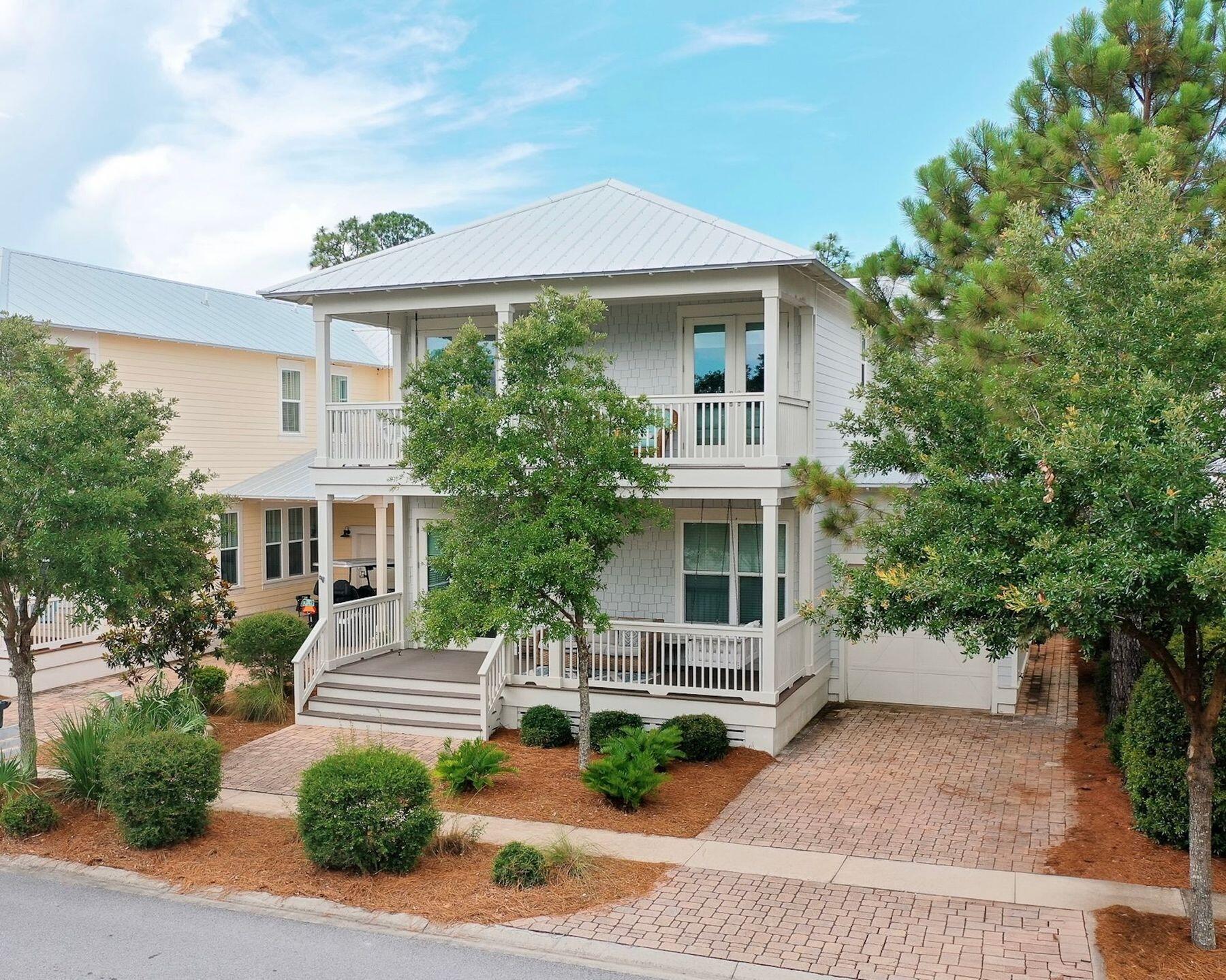 At SeaHunt, comfort and style unfold with ease in the heart of NatureWalk at Seagrove; a prized community bordering Watercolor and Seaside on Hwy 30A. Designed to accommodate both laid-back beach days and lively family gatherings, this five-bedroom retreat offers gracious living surrounded by nature preserves, resort-style amenities, and a warm, coastal aesthetic. The main level welcomes with bright, open spaces wrapped in natural light and French doors that open to a spacious screened porch. The kitchen is a true standout, with granite countertops, a generous island, gas range, stainless steel appliances, and a large walk-in pantry. A first-floor guest suite adds flexibility for multi-generational stays, while the upstairs primary suite offers a peaceful sanctuary with a soaking tub, walk-in shower, and screened balcony overlooking the community forest. Two additional guest rooms share a charming front balcony, and the oversized bunk room with two twin-over-full bunks comfortably sleeps six. Outdoors, the back patio is perfect for grilling after a beach day, and the screened porch invites slow mornings with coffee or shaded evenings with cocktails. NatureWalk's amenities include a large zero-entry pool, a seasonally heated lap pool, a shaded kiddie pool, a hot tub, a playground, a bar area, and grilling stations, all set amidst trails that weave through untouched native landscapes. Whether you're seeking a family home, a luxurious vacation escape, or a rental investment, SeaHunt delivers laid-back luxury in a location that's equal parts secluded and connected