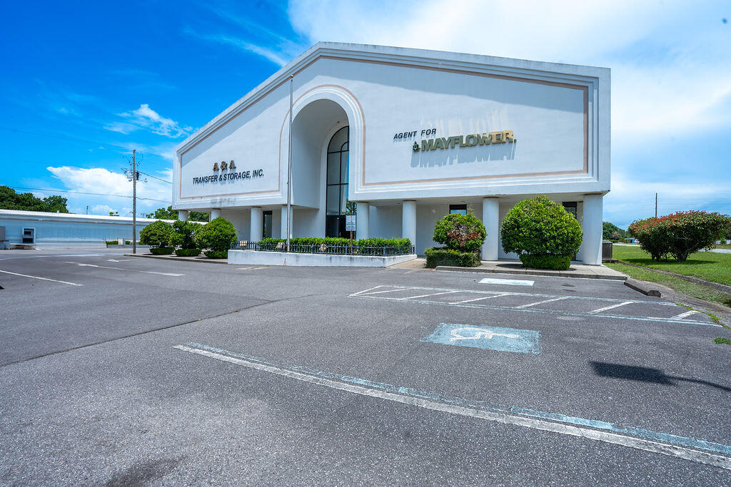 This two-story, 10,000 sq ft office space is fully heated and cooled with dedicated parking spaces. The first floor has 9 offices (2 with private bathrooms), a reception area, 2 public restrooms, a kitchen, conference room, and a large flex area. Upstairs includes 6 additional offices (2 with private bathrooms), another kitchen, 2 restrooms, and multiple large flex spaces. With two staircases and a functional layout, this property is ideal for a variety of business uses. This property offers 24,000 sq ft of warehouse space across two buildings with loading docks. The front warehouse totals 16,000 sq ft, including 2,000 sq ft of heated and cooled office/flex space, 3 roll-up doors (12'x14'), and 3 bathrooms. The rear warehouse offers 8,000 sq ft with 2 roll-up doors and a truck scale.
