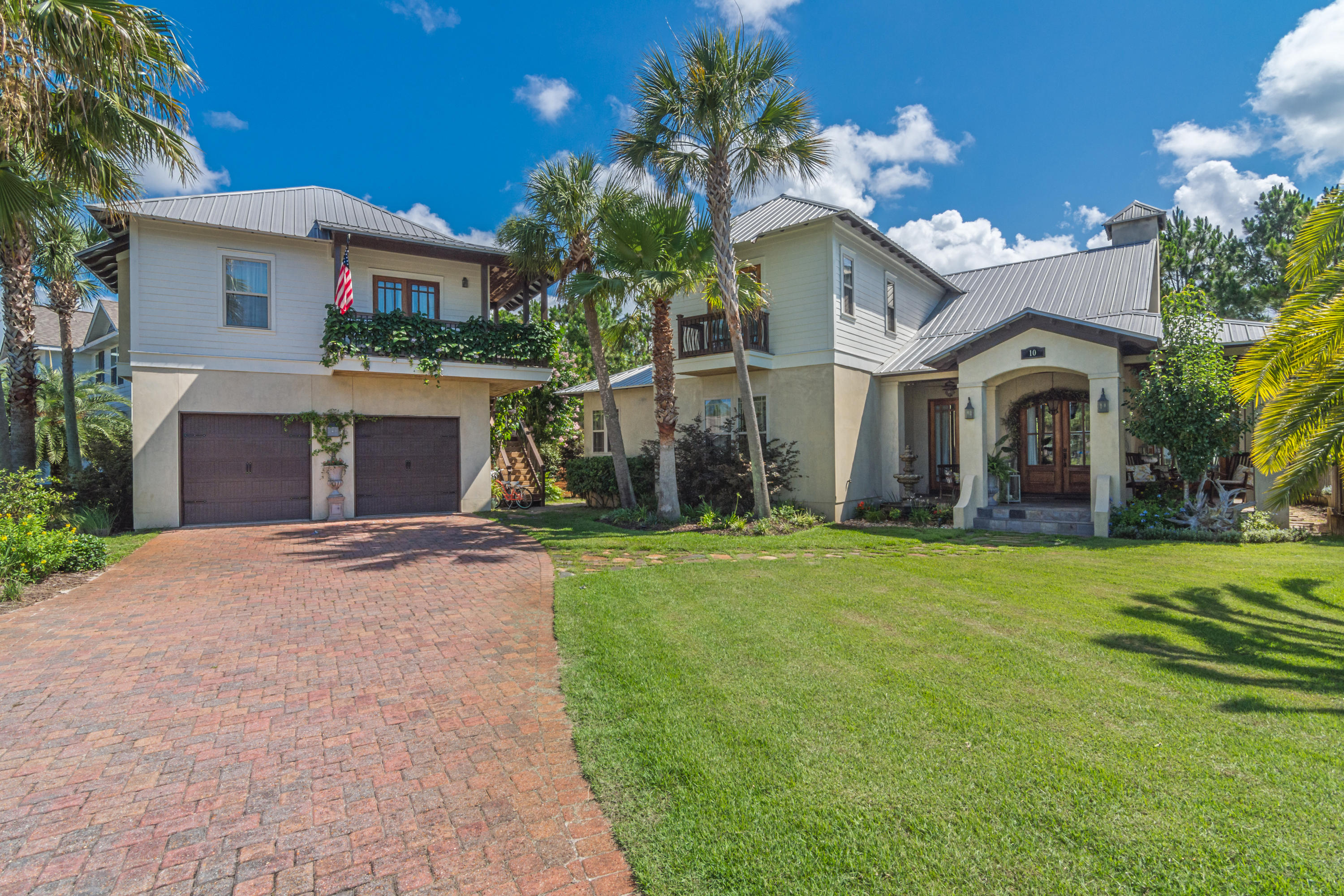 Amazing custom-built Florida home in gated Cypress Breeze Plantation, just over half a mile to the beach! This two story 4-bedroom, 41/2 bath home features first floor and second floor master suites. The second floor master suite has a lovely outside sleeping porch. French-influenced mahogany doors surround the home's exterior, with oversized porches, slate walkways, lush landscaping, and adjacent protected forest area. Kitchen features two gas stoves, oversized freezer and refrigerator, two dishwashers, separate butler pantry with wine closet, built-in coffee/expresso machine. Above garage is carriage house with fully equipped living space/kitchen, (4th) bedroom/bath, washer/dryer. This beautiful home has many more amenities to see! This property could also be a great Vacation Rental! Enjoy the celebrated sights and sounds of 30A, Gulf Place shops, restaurants, and beach access at the beach access.  There are many options nearby for dining and entertainment and you are close to the picturesque towns of Seaside, WaterColor and Rosemary Beach.  Cypress Breeze is an exciting, active, and unique community which contains the truly spectacular Cypress Breeze Lagoon community pool.  This is a perfect place to entertain, unwind and enjoy the coastal lifestyle!
Enter your new home through the beautiful mahogany doors into the foyer area to enjoy the stunning design features in the home.  Warmed by the spacious living room with natural wood beams crossing above and oyster laced chandelier, you are ready to entertain friends and family!  The large pass-through fireplace is also visible to you while relaxing with a good book in the library. Double French style mahogany doors enhance each space with plenty of light in the house, and easy access to the spacious porches.  The living room flows into the well-equipped kitchen, ready for your expert cooking skills featuring two gas stoves, over sized individual freezer/refrigerator, plenty of pantry storage, two dishwashers, microwave, and lots of cabinet/storage space.  Prepare your favorite beverage in a separate butler pantry area with an Italian themed wine closet, upper and lower cabinet space, ice machine, open stemware shelving, and most interesting very well received built-in Bosh coffee/expresso machine.  
This two-story 4-bedroom 4 1/2-bath home features customized elements with each bedroom/bath area.  Choose either a first-floor or second-floor master suites.  Melt away in the antique clawfoot tub, spacious bath area and plenty of closet space in the first-floor master suite.  Somewhat larger second-floor master suite has plenty of seating space, ample closets, jacuzzi tub, and rain shower. Brazilian craftsmen laid travertine tile enhances each bathroom shower areas.  Retreat in your self-made haven outside the master bedroom onto the sleeping porch.  Tree limbs sway in the coastal breezes while you sink into your respite and enjoy the natural views, sounds, and peaceful setting.  
The Carriage House captures the best sunset views from the large L-shaped balcony, and bright coastal designed living space.  Above the 2-car garage the carriage house introduces another fully equipped living space with elevated ceilings, full kitchen, separate (4th) bedroom/bath, and washer/dryer providing apartment style living for potential short-term or long-term renters.
The outside of the home is influenced by the French mahogany doors surrounding the homes exterior.  Enjoy the front and rear oversize porches, with plenty of room for outdoor grill area, dining, and comfortable seating.  Slate stone walkways enhance the landscaping filled with palms, and lush plants.  Enjoy an outdoor gas firepit as you look beyond into the natural protected forest area, a wonderful private area all your own!  
The home has many enhancements to note. The home is built to hurricane standards featuring impact windows and single or double mahogany doors throughout the property. Your investment is energy efficient with unique 2x6 exterior wall framing, icynene spray foam insulation, 3 electric HVAC units with plenty of service capacity.  Natural gas was brought in to provide an energy efficient Rinnai hot water heater, gas ventless fireplace, double oven/cooktop, and service the outside firepit.  Enjoy the wired speaker system in the house, and security system.