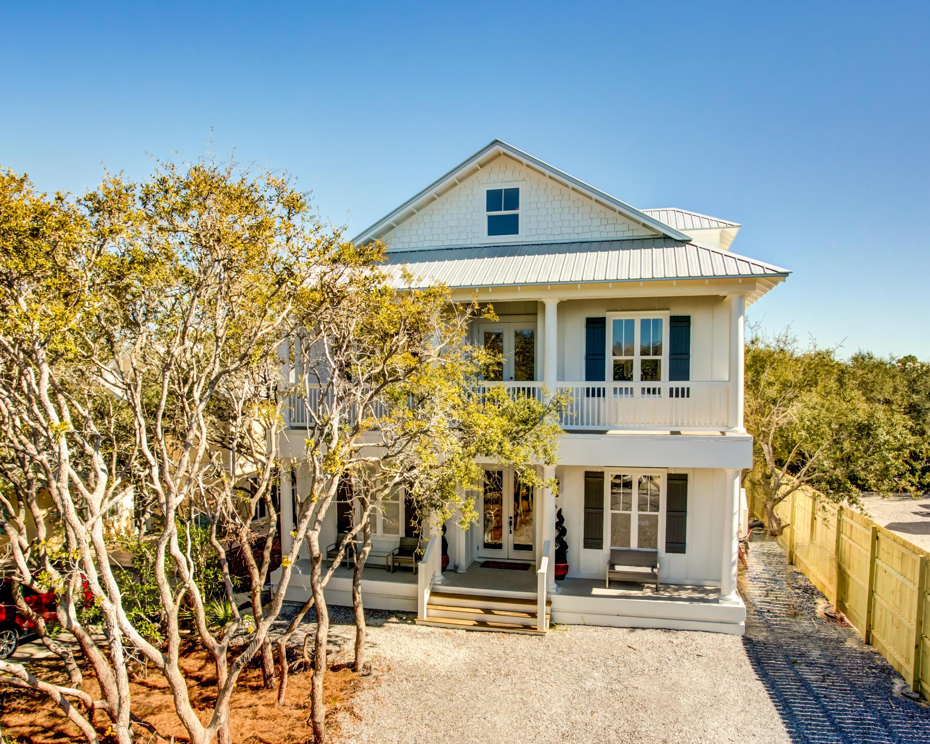 Gorgeous new construction in one of the most desirable stretches of 30A! This stunning 3-story home is not only beautiful but bright, spacious and loaded with conveniences! Featuring high ceilings, scraped/recycled walnut floors, incredible white marble countertops sealed with M3 sealant, and modern fixtures, it's perfect for a beach lifestyle that is both elegant and relaxed.
The fabulous kitchen offers a huge island with breakfast bar and pendant lights, extensive white cabinets, and a large, undermount stainless sink. The appliances are all stainless Thermidor, including a 48 range with custom hood, a 48 fridge/freezer, professional dishwasher, and more. The adjoining living area opens to the back porchand both enjoy gas fireplaces for indoor/outdoor living and year-round comfort The floorplan offers some flexibility: the first-floor includes a master suite with soaking tub, separate shower, dual vanity, and walk-in closet, and an office or second bedroom. The second floor offers another master suite with adjoining bath, a large family/media/playroom, which could also be a sitting room for the upstairs master suite, a smaller attached room which would make a great office, playroom, or bunk room, and a large deck overlooking the fully fenced backyard. Two additional bedrooms, a shared bath, and a balcony comprise the remainder of the second floor. The third floor, currently used as a music room plus storage, has lots of options such as media room, playroom, bunkroom, and/or quiet office hideaway--especially in front of one of the gulf view windows.

Superior construction specs include stem wall solid concrete foundation, 2x6 framing, shatter-resistant windows and doors, hardy board siding with a 20-year guarantee, and a 160-mph rated metal roof. The home has full-house WIFI and a dual security system accessible via smart phone. It also includes a Renai 9.4 gas hot water system ensuring you never run out of hot water, and an HVAC system with controls for each of the 3 floors. With its own entry, the laundry room doubles as a mud (sand) room.

This residence is within easy reach of 30A, the gorgeous Emerald Coast beach, and less than a mile from Seaside--so plan to park the car and pull out your flip flops, bicycle, or golf cart to enjoy the beauty of nature and the local restaurants, shops, grocery stores, and hot spots! Plus the home has no HOA fees!

Buyer to verify all dimensions and specifications.