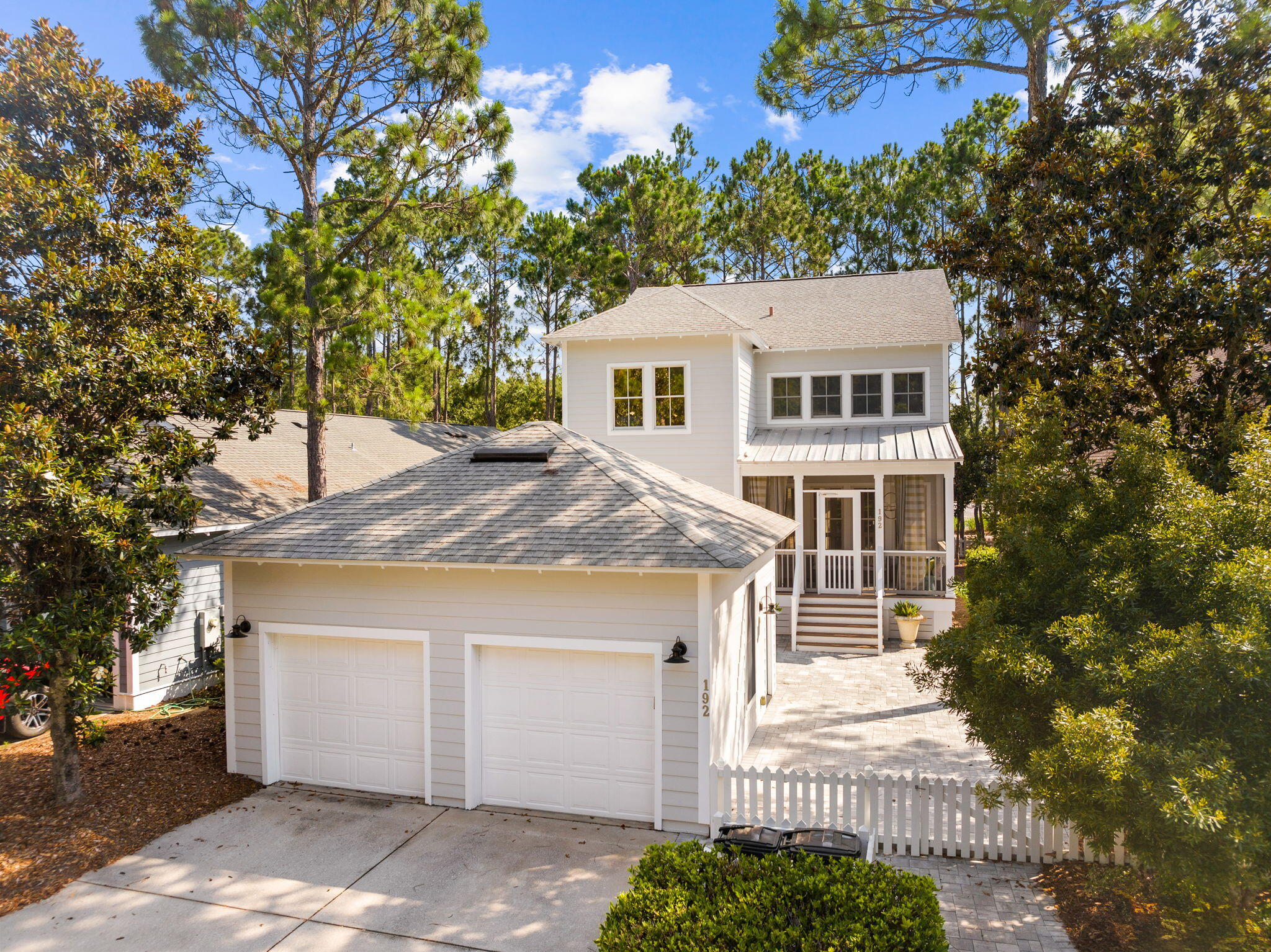 Discover an impeccably maintained two-story residence in the coveted WaterSound Origins community! This stunning 5-bedroom, 3-bath home, encompassing 2,741 square feet, is perfectly positioned across from the Village Commons amenity complex. The main level boasts an inviting open-concept kitchen, dining area, and living room with cathedral ceilings, all illuminated by abundant natural light. The kitchen features Quartz Cambria countertops, black appliances, a downdraft cooktop, and a microwave/oven combo. Hardwood floors grace the kitchen, breakfast room, family room, and study. The first floor also includes a bedroom, a full bath, and two spacious screened porches.