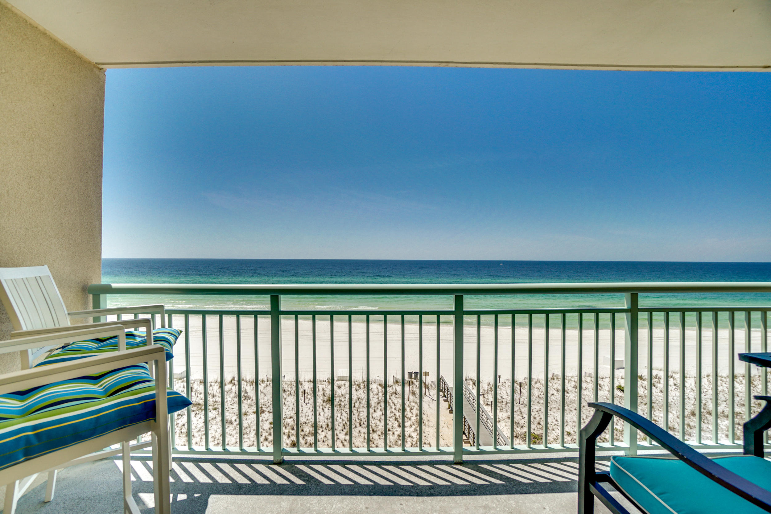 UNDER CONTRACT ACCEPTING BACK UP OFFERS These amazing wrap around lanais and coveted parking spot are not to be missed! Gulf views from this 2BR/2BA, 1,356SF end unit at Pelican Isle. This condo is bright and beachy with additional windows, new laminate wood flooring in the bedrooms, a relaxing large wrap-around balcony and an additional balcony off of the bedrooms. The kitchen features tile floors, a desk area, plenty of cabinet & counter top space, and a breakfast bar. The kitchen opens to the living space which has beautiful views and two access points to the wrap-around balcony. There are two nice sized bedrooms, one with a private bath and one with access to the hallway bath. Other features include hallway bunks, washer/dryer, and a deeded parking space right next to the lobby for the ultimate in convenience Pelican Isle amenities include 300 feet of deeded beach, community pool, hot tub, & workout room.