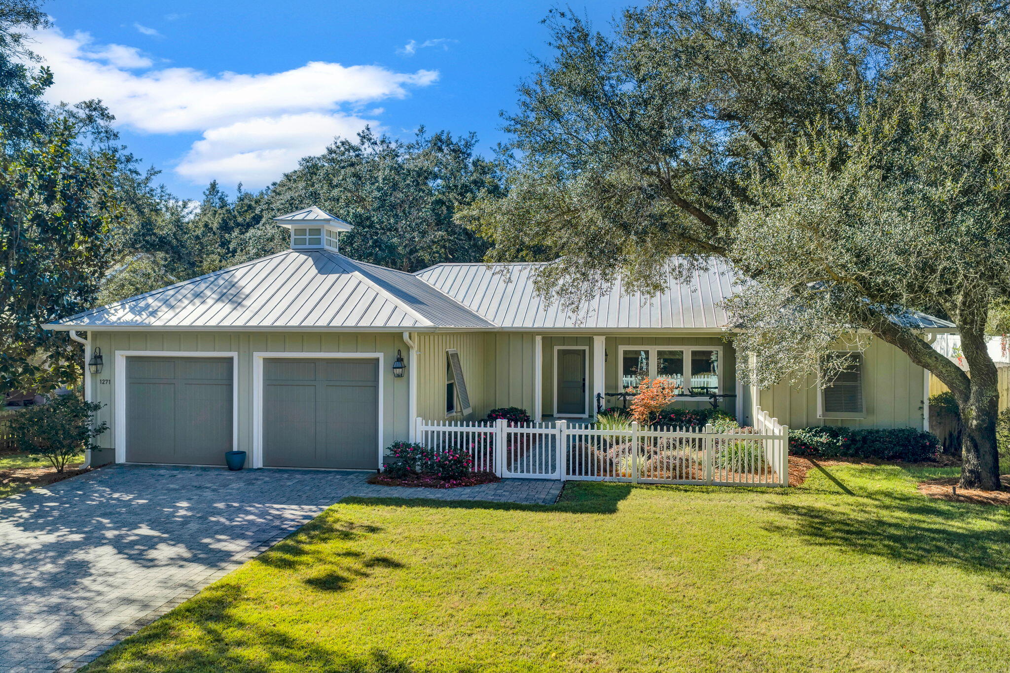 Welcome to 1271 Ainsworth Dr. This charming, custom-built home sits on a beautiful lot with mature Live Oaks, Magnolias, and Azaleas. The gated courtyard and custom front porch handrail set the tone for the quality and craftsmanship throughout. As you enter the home you step into a beautiful open floor plan with wood floors, a kitchen with island, granite counter tops, a living area with wood-burning fireplace and an 11' x 18'7'' studio/office. Main bath features a large closet with washer, dryer, and utility sink.  This home has impact windows, metal roof, Hardi-Board siding, composite deck, and paver driveway. Community park w/ tennis courts & playground nearby. Just 6 miles to Pensacola Beach and 10 miles to downtown. High and dry in Flood Zone X. Open House: Dec 13 | 11:00 AM - 2:00 PM