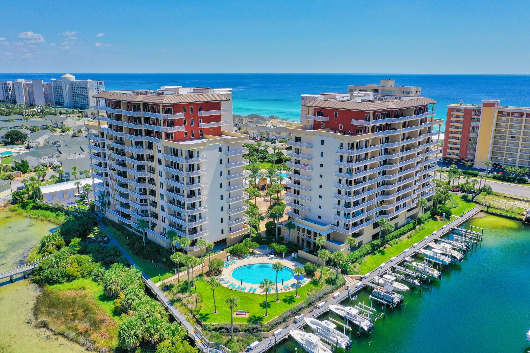 You have an incredible opportunity to own this 8th floor corner unit with rare private garage space and a deep water boatslip!  In addition, there is no one above this unit, making this a haven of peace and quiet.  Fabulous layout, with open floor plan that encourages large family and friend get togethers.  Each bedroom has the privacy of their own bathroom.  Master bath completely remodeled.  Bonus powder room for your guests.  Neutral colored walls and flooring lead your eyes to enjoy the magnificient views of the harbor and gulf of Mexico.  Gorgeous white counter kitchen island with gray cabinetry.  Expansive covered balcony offers abundant space to relax and watch the Thursday night fireworks over the harbor or observe the unique wildlife like manatee, dolphin, osprey and wild heron. Take your boat out to deep sea fish, cruise to crab island or eat at one of the water front local seafood restaurants.  Harbor Landing offers the best of Destin to residents and guests.  With private deeded beach access to the sugar white sand beaches of the gulf of Mexico and the opportunity to get on a boat in the harbor for gulf and bay fishing or cruising without leaving your property, you won't find a more convenient location in all of Florida.  The gated community of Harbor Landing offers two pools, a workout center, deeded beach access and a private marina.