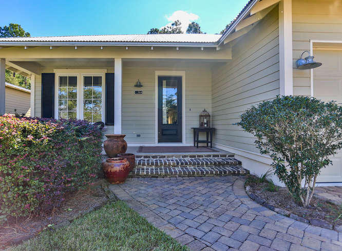 IMPECCABLE! Available for the FIRST TIME this one owner single story craftsman beauty is a home to behold!
The cozy front porch welcomes you through a full view front door into this tasteful home. The screened lanai is accessed through two sets of double doors from both the family room and dining rooms. Upgrades galore! Hurricane windows, granite counters, tile floors, glass showers, expansive garage & extended area for workbench, the list goes on! Three bedrooms with three FULL baths make this home perfect for you & your guests. The remote Master ensures privacy while the open living space is great for gathering! Neutral colors throughout with soaring ceilings, recessed lighting, ceiling fans & stainless appliances. You will love the warmth of this chic modern craftsman! The NEWLY tiled back splash and large laundry room is reason enough to want to see this one.  Homes rarely come available in Carson Oaks, don't miss your chance!