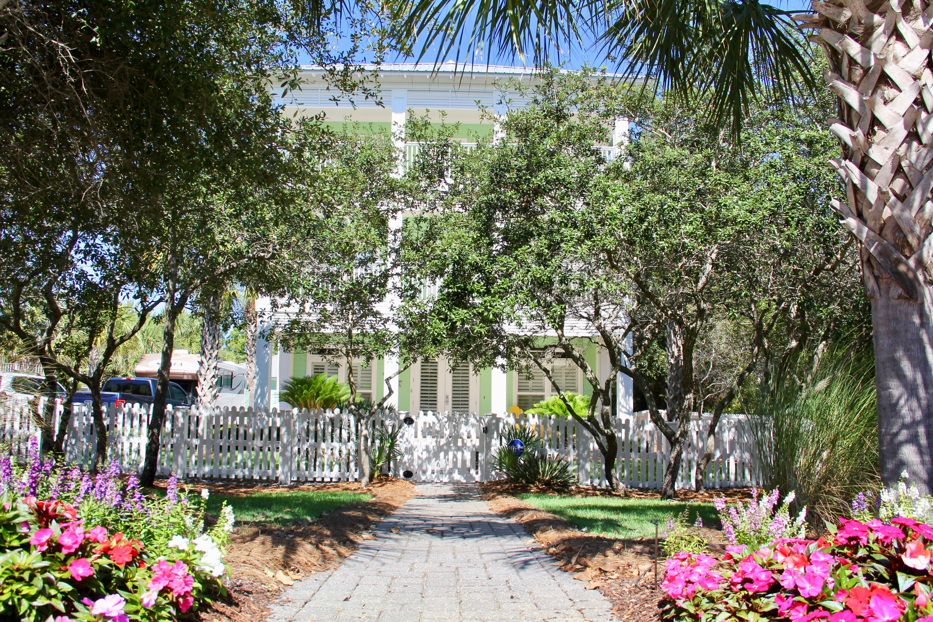 Here it is, a home that has NO HOA, nestled just a short distance to the beautiful Gulf of Mexico on a 1/4 acre lot, tucked away like a Southern Plantation home. Drive onto your brick paved driveway through your privacy gate accented with a white picket fence that can accommodate a motorhome , guests with a detached 2-car garage. That's not all, you have the convenience of your own heated swimming pool, plenty of seating all surrounded with brick pavers. Separate pool / storage building behind the garage for storage. Manicured landscaping front and back with fruit trees and grass for your children and pets. Let's begin the tour....large open porch greets you into your open concept living room / kitchen / dining area with laundry and guest bathroom on the first floor. You can enjoy those cold days or just a romantic evening with gas fireplace. Tiled floors throughout the first floor with an enormous kitchen with two refrigerators, 2 dishwashers and large porcelain farm sink.  The kitchen bar can seat 6 - 8 along with a dining table and breakfast nook for seating.  Exit out the french doors to a screened in porch overlooking the pool.  Going to the 2nd floor, there is a large master bedroom with a king bed, walk-in closet and a screened-in porch that over looks the pool.  Master bath features a claw-foot tub, separate tiled shower, double vanity with Kohler sinks, ensuite and tiled flooring throughout.   With two additional bedrooms, one features a queen bed and the other a bunk with single on the top and a double on the bottom.  Each bedroom has access to a  large covered, open porch that faces the street.  All bedrooms have carpet.  Guest bathroom has a tub/shower tiled surround with tiled flooring.  The 3rd floor features another master suite with screened-in porch overlooking the pool.  Master bathroom has a separate tiled shower, ensuite, claw-foot tub, double vanity with Kohler sinks and tiled flooring.  Gulf views from the decks and porches and master bathroom.  There are 2 guest bedrooms that open out to the covered porch with gulf views. One bedroom will have a queen bed and the other bedroom with bunks, top with a twin and bottom is a double.  Guest bathroom has a tub/shower combination with tiled floors.  Having a gas rinnai, your family and guests will have continuous hot water.  All three air conditioners have been replaced, one in 2015 and the other 2 in 2016.  These owners never rented the home, a place to relax and enjoy their privacy so close to the beach. Home was completely repainted and re-caulked last year.   It can accommodate at least 18 people easily with the sleeping arrangements ( a sleeper sofa, 2 king beds, 2 queen, 2 twins,  2 double and under the double is a trundle  which sleeps 2).  The owner's closet is on the first floor under the stairs and a storage closet on 2nd and 3rd floor.   You can walk to the restaurants, go for a bike ride on the bike path or go for a stroll on the beach within minutes.  There is also a 30 and 50 amp electrical hookup box for a motor home.