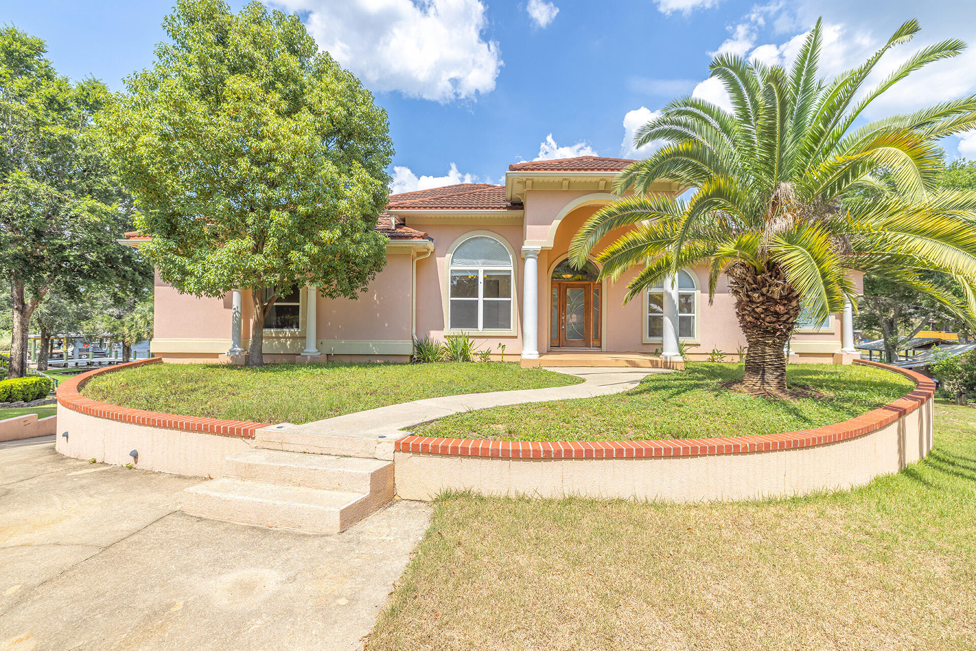 Enjoy WATERFRONT living at its finest! Custom built executive home with DEEP WATER access to Rocky Bayou. Located at the end of a cul-de-sac, this beautiful home features 5 bedrooms, 3.5 bathrooms, and an oversized 3-car garage. Open floor plan with a large screened in balcony where you'll delight in colorful sunrises, afternoon breezes and magnificent sunsets over the canal.
Spacious living space with high ceilings, crown molding, and a fireplace surrounded by built-ins. The kitchen offers granite countertops, stainless steel appliances, and travertine flooring.
Luxurious primary bedroom with walk-in closet, and private access to the screened balcony; the relaxing en-suite bathroom features a double vanity, soaking tub, and separate tiled shower Downstairs you'll find a large bonus room which could be used as a workout studio or media room. 
This home comes complete with a vinyl seawall, dock and boat lift- perfect for fulfilling all your boating ambitions.
This waterfront home won't last long!
