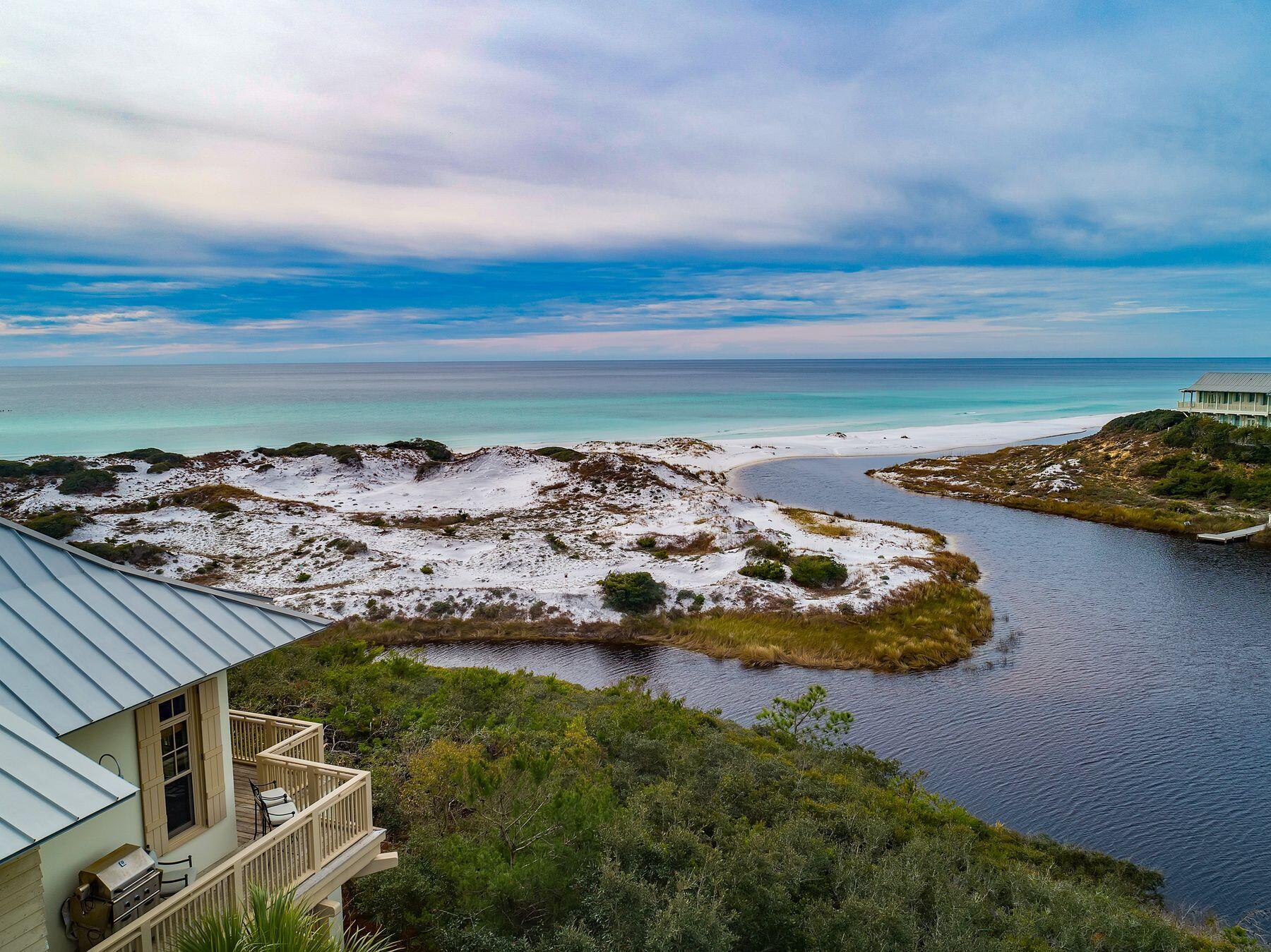 Set on one of the most coveted parcels along 30A, this iconic residence in the private community of The Retreat delivers a truly rare opportunity. Perched high above the dunes, it commands breathtaking vistas of Draper Lake's outfall and the shimmering Gulf of America. Offering an extraordinary blend of elevated privacy and generous lot size, this Tom Christ-designed concrete block masterpiece sits gracefully within a 90-acre enclave boasting 3,000 feet of private beach. 

Inside, reclaimed heart pine floors infuse warmth throughout the reverse floor plan, while pro-line appliances, a two-car garage, and timeless finishes elevate everyday living. This is not just a coastal residence, it's a rare chance to own one of The Retreat's most extraordinary homes!