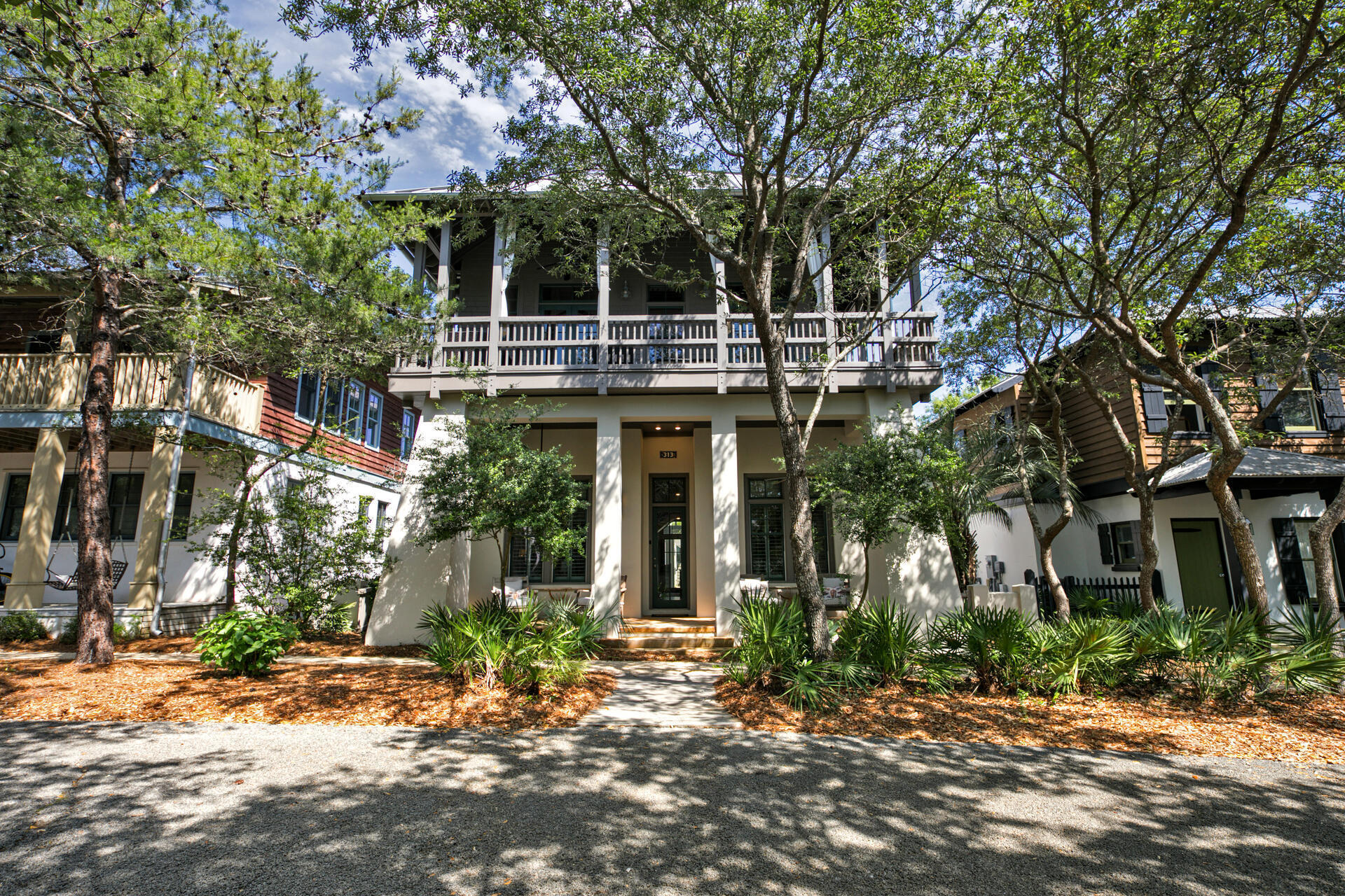 This south of 30A Rosemary Beach home with a private hot tub and pool has gulf views and is just a short walk to the east green beach access and minutes from the town center.  The natural wood craftsmanship creates a cozy and inviting environment for your family memories at the beach.  Boasting 4 bedrooms with an additional bunkroom/gameroom, this home can accommodate up to 14 guests.  There are 3 full parking spaces on this property as well.  

From the back of this charming home, the outdoor area invites you in with the gorgeous pool and spa that features a complete outdoor kitchen with built-in alfresco gas grill, granite countertops, U-Line ice maker, and refrigerator. Plenty of seating options offer you space to dine, relax, and recline while taking in the infinity spa which cascades  into a beautiful pool with a waterfall feature and LED lighting. 
There is also a beautiful outdoor fireplace for cool evenings as you relax and listen to your favorite music. The entire house (including outside living area) has the Sonos music system throughout, so you can use your laptop or smartphone to play any of your favorite music!