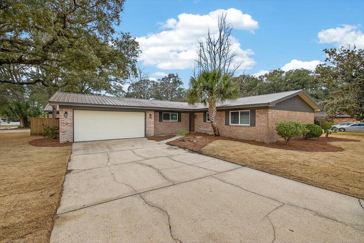 Beautifully renovated 4-bedroom, 2-bath home, ideally situated on a spacious corner lot with a fenced backyard. The property offers a 2-car attached garage plus a 25x25 detached garage with spray foam insulation. 
Luxury vinyl plank flooring flows throughout, and impact-rated windows and sliding doors provide added protection and potential insurance discounts.

The kitchen features white shaker cabinets, a large island, granite countertops, and stainless steel appliances — perfect for cooking and entertaining.

Both bathrooms have been fully updated with custom tile, showers, vanities with granite, and new lighting, while spacious bedrooms provide comfort and versatility.

Enjoy fresh landscaping with a new lawn pump, and timer, making yard maintenance a breeze.

A transferable termite bond is in place, recently renewed, and valid through January 2027.

Conveniently located in Niceville with easy access to local military bases, top-rated schools, shopping, dining, and just across the street from Northwest Florida State College, this home perfectly combines style, functionality, and location.