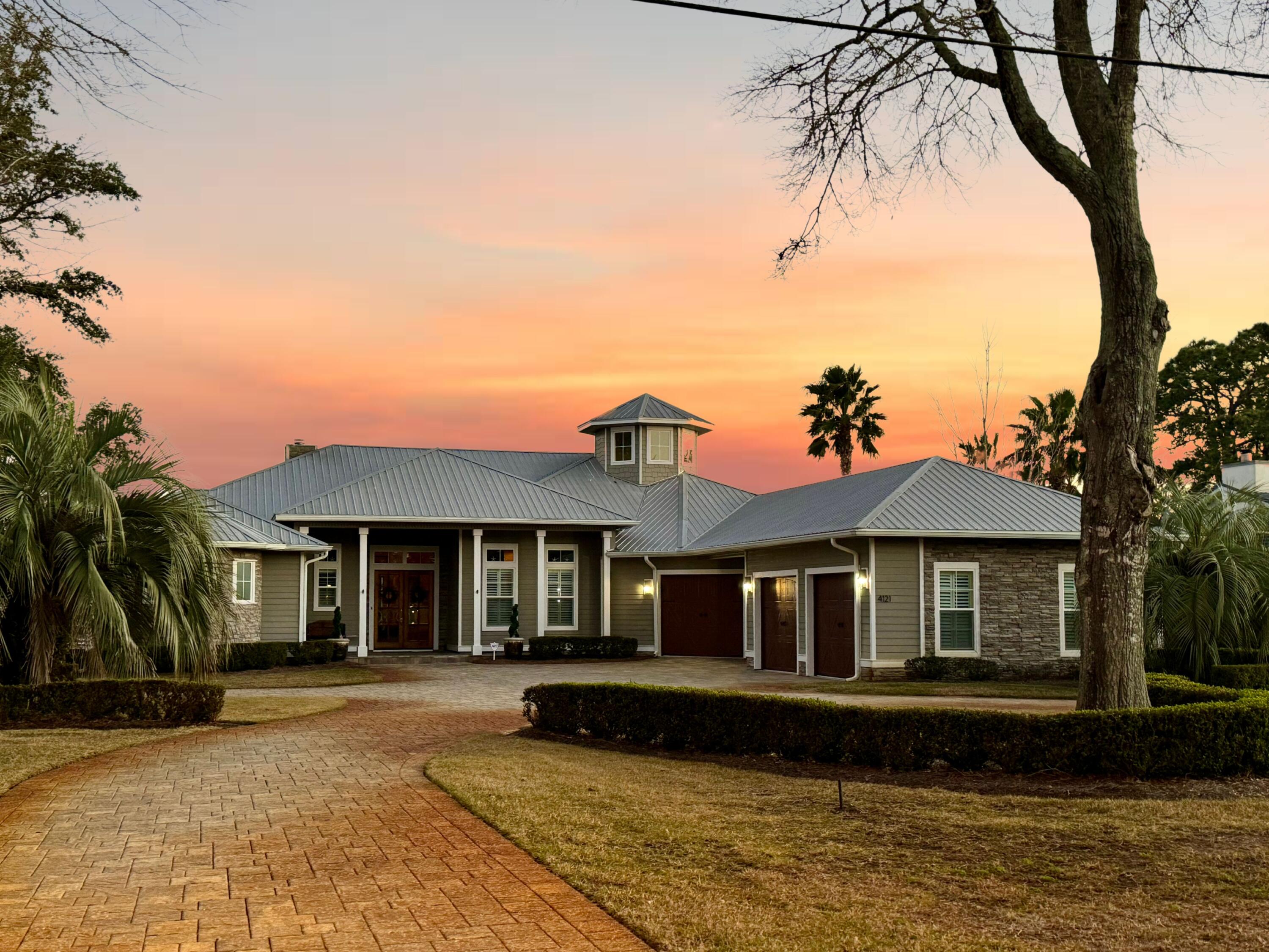 Kick out clause in place. Welcome to your dream waterfront retreat situated on .54 acres with 100 feet of Bayou frontage (Boat included). We are delighted to present this captivating 1-story, 3 car garage home nestled along the water, offering unparalleled views and convenient deep water boat access with power and water on dock with lift for boat and jet ski. New Trex added to dock 2023! The home offers 4 ( the 4th is used as a office currently) bedrooms with 3.5 bath. The outdoor entertaining area is completely screened with gas fire place to enjoy all year long. Stepping out from the lani into tranquility with a backyard that extends to the water's edge. Enjoy peaceful evenings and breathtaking sunsets from your own slice of paradise.Nestled in the heart of Destin this home offers both privacy and convenience