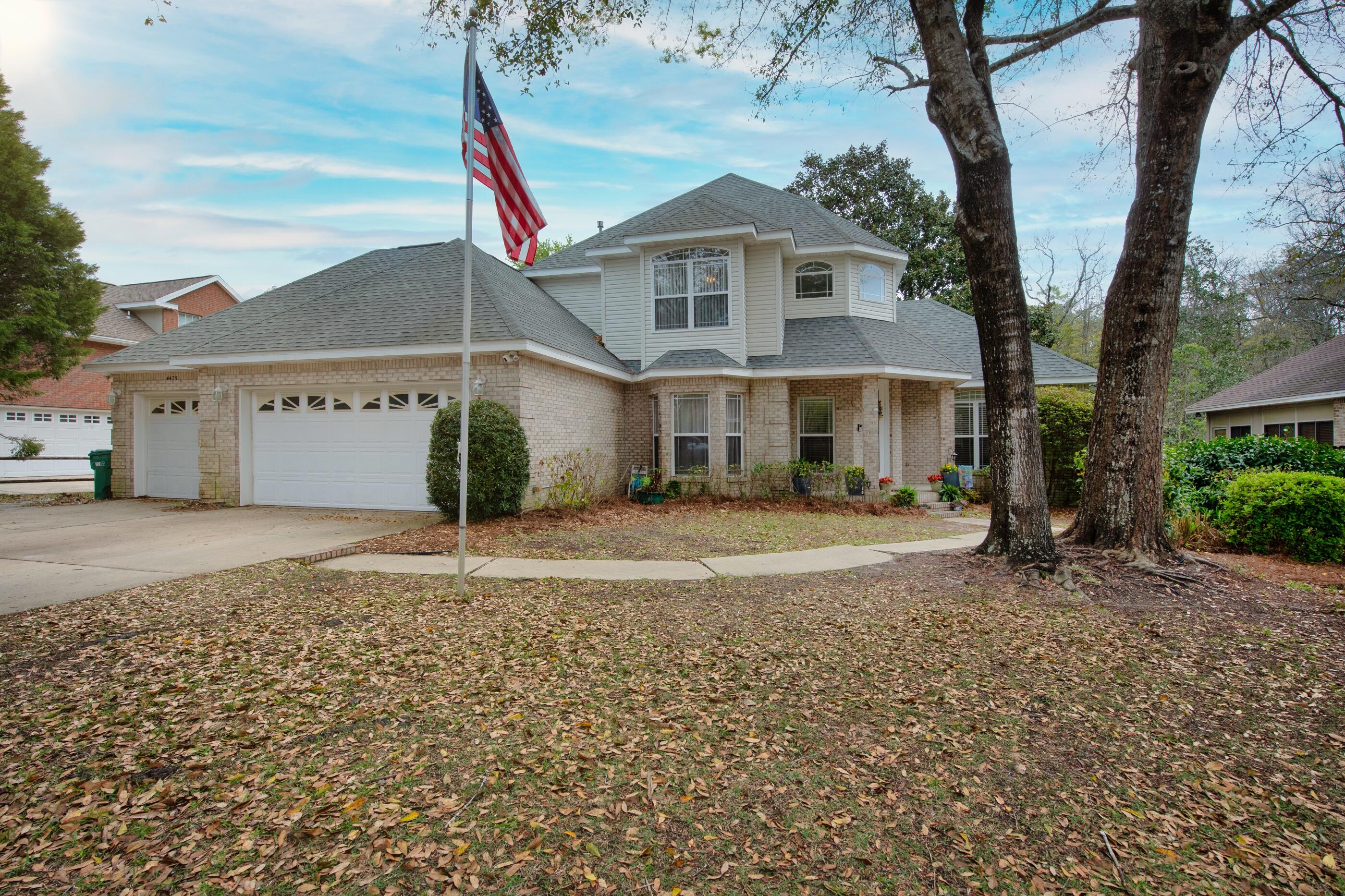 SELLER WILL CONTRIBUTE UP TO $5500 IN SELLER CONCESSIONS!!! Roof 2017, Dual zone HVAC with smart thermostat 2017, gas WH 2022, hard-wired WHOLE HOUSE GENERATOR.. Don't miss your opportunity to own this beautifully remodeled (2019) mostly brick, 3-car garage home. There is wood-like tile throughout the downstairs, recessed lighting, fans in all the rooms. There is a HUGE formal dining room AND eat-in kitchen.  The chef in your life will LOVE the abundance of beautiful granite counter tops, newer soft-close cabinets, two FULL-SIZE wall ovens, a prep sink in the island with garbage disposal, gas stove, an oscillating overhead fan, brick-like backsplash. The view out the kitchen bay window and screened in back porch look out to the woods of the Eglin AFB Reservation. You get beautiful views of native plants, flowers, and wildlife. The spacious screened-in porch has tile flooring and is a great space to sit and enjoy the serene views bug free and with the breeze of the outdoor fans!  Its also a great space for entertaining and grilling out; complete with gas hook up. There is an awesome doggie door through the deck with brand new steps. The master bedroom is on the first floor and features trey ceilings, sliding glass doors to the Florida room (that is like a wall of windows with views of the Reservations, too!) The master bath boasts dual sink vanity with quartz countertops, soaking tub, walk-in shower with tile surround, 2 shower head one that is similar to a rainwater shower, large walk-in closet with custom built-in organizers.  Other great features:  central vacuum, outdoor stone fire pit, perfect for warming up on chilly nights, all bathrooms have quartz counters and new cabinetry, the 1/2 bath downstairs has a beautiful barn door.  There is an abundance of storage. The laundry room has granite counters and additional cabinets. Garage has cabinets and utility sink, the shelves in the garage will convey.