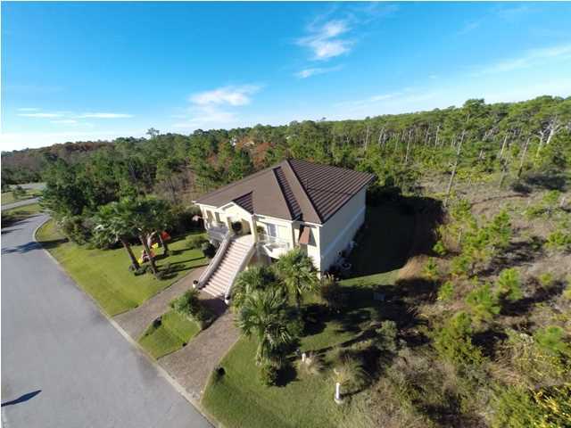 Custom, Elegant, two story home located in Cypress Breeze Plantation approximately 1/2 mile from the Gulf of Mexico. Kick back and enjoy the lifestyle the Beaches of South Walton has to offer. Bike ride to nearby Ed Walline public beach access, Gulf Place, restaurants and shoppes of 30A or enjoy the magnificent community pool with waterfalls and plentiful deck area. A conservation area surrounds two sides of the home for privacy. Climb the Trex decking staircase with courtesy lights or drive into one of two garages via a paver driveway to take an elevator to the second story of the home. The main living area located on the second floor has Hardwood Brazilian Cherry floors, Spanish Lace ceilings, bullnose corners, crown molding, 10' ceilings, 6'' baseboards, and a central vacuum (featuring central dust pans). To the left of the foyer is the formal dining room with a tray ceiling and chandelier dimmer. The dining room leads to a ''perfect for entertaining'' kitchen featuring colorful pendant lights over a 14 foot granite breakfast bar with seating for 6, two dishwashers, refrigerator with bottom freezer, several glass front Cherry cabinets, two Thermador (convection/traditional) ovens and a gas 6 burner stove with griddle and pasta water spigot, ''artsy'' tile back splash, Jenn-Aire flue exhaust, hot water dispenser, central island,and gathering table height granite bar area with built in wine cooler, wine rack, automatic lighted generous food pantry, bar sink, and ice maker. The kitchen leads to a convenient home office with bamboo flooring facing the front of the home. A dining area overlooks the Travertine tiled back patio with three sets of tinted patio doors extending the entire length of home, and dimmer lights over the dining table area. Features of the living room include can lighting, floating shelves flanking the gas/vent-less fireplace, wired for surround sound with openings for electronics. A half bath is located on the second floor with an indigo blue bowl sink and faucets mounted on the white natural wall tiles. The master bedroom features access to the patio and a two large walk-in closets, jetted tub, beveled glass mirrored double vanity, custom cabinets, towel warmer, porcelain ceramic tile flooring, rain spout walk-in shower, and four body shower nozzles. A full size laundry room with Kenmore Elite washer and dryer, laundry sink, and pretty chandelier is accessed from the master bath. Before heading downstairs you will find a full coat closet with access to the attic upstairs and a linen closet under the stairs. A family room overlooking a patio (a private back-yard beyond) is located at the foot of the stairs featuring can lighting, accent lighting, and a sink, refrigerator and microwave. The main level patio has a gas hook-up for a grill and plenty of seating area. The bedroom to the left of the family room has a private bath with a deep garden tub, ceramic tile,and beveled mirror. The guest bedroom has a pocket door leading to a full guest bath as well as access to the outdoor patio. Two large garages on main level contain an extra laundry area with sink, a second washer and dryer (all convey) a separate storage room, garage cabinets, security side entrance and motion sensor light. Iron remover system on sprinklers keep Zoysia grass velvety soft . Other features include hurricane shutters on every window, water filtration system, and a convenient outdoor shower when coming back from the beach. A Girard steel roof (looks like tile) provides protection and is aesthetically pleasing.