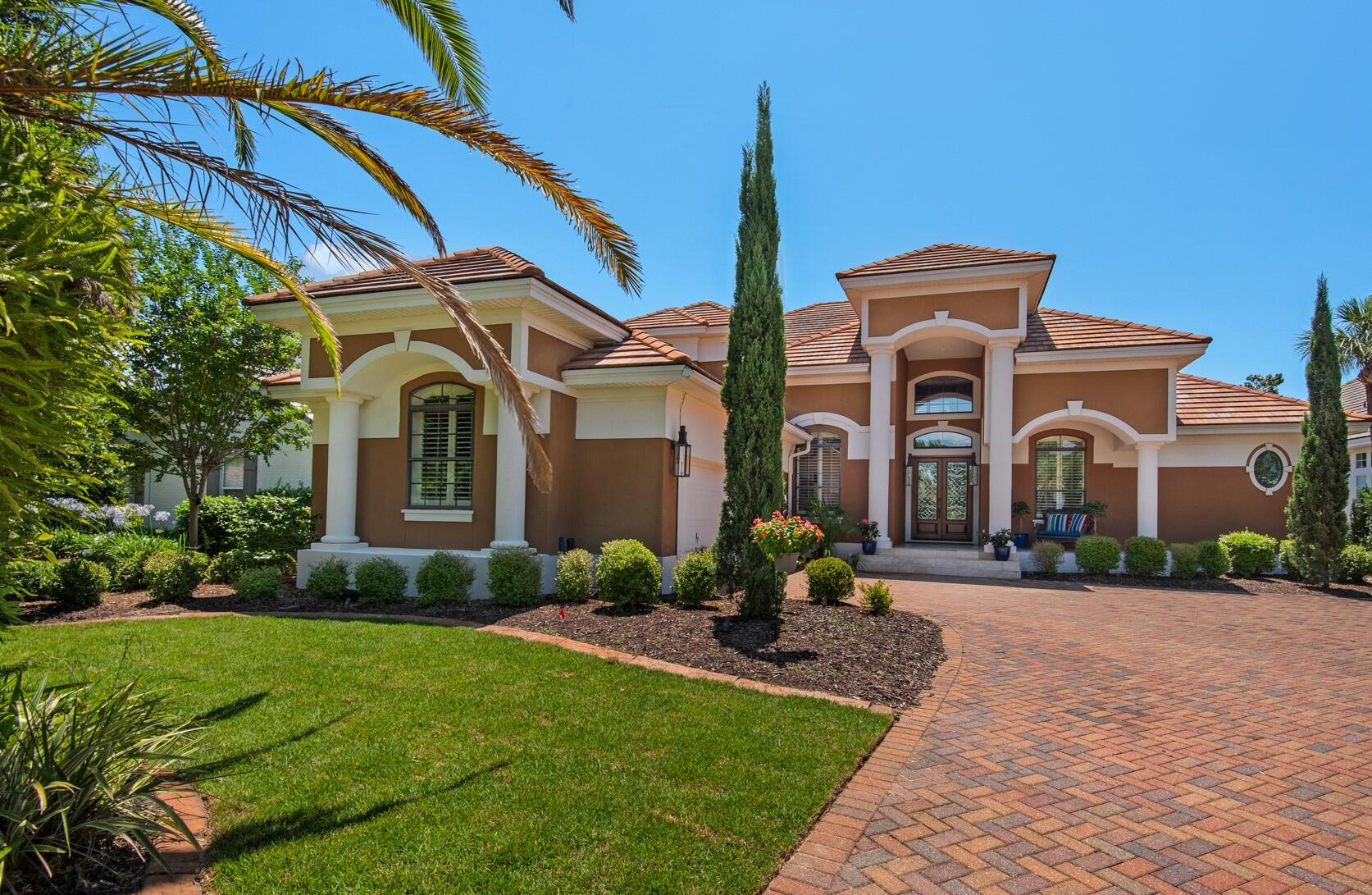 Welcome home to this gorgeous Mediterranean home nestled on the 15th green of Regatta Bay's impressive 18-hole golf course. It boasts a recent $100,000 kitchen renovation featuring quartz countertops with up-lighting, new cabinets, new stainless Wolf gourmet appliances, a Subzero refrigerator, sink, faucets, fixtures, and more. The soaring 22' ceilings in both the living and family rooms create expansive energy with plenty of sunshine, crown molding, and recessed lighting.
The private master suite enjoys double french doors leading to the private pool and lanai with a summer kitchen and spa, as well as double walk-in closets, a luxurious jetted soaking tub, a spacious shower with dual shower heads, and a double sink vanity. The second-story loft not only overlooks the living and family rooms, but it features a coffee bar and leads to a private screened porch with a swinging bed and a private bedroom suite. The lushly landscaped homesite enjoys oaks, palms, and brand-new Zoysia grass.
