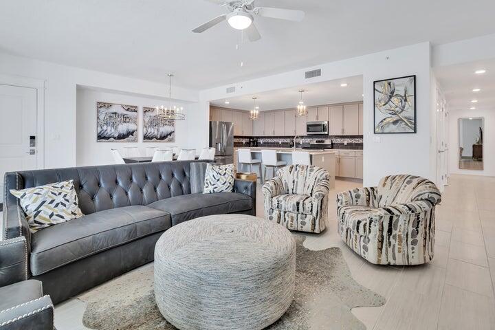 Perched on the top floor of the exclusive BLU condominium, this fully furnished, turn-key Gulf-front residence offers a rare blend of sophisticated coastal living and proven rental performance, generating over $125,000 annually with consistent year-over-year growth. Designed with intention and executed with elevated style, this three-bedroom, three-bathroom + media/bunk room home is perfectly suited for both the discerning vacationer and the savvy investor. The professionally curated interiors showcase a refined coastal aesthetic, complemented by an expansive open-concept layout that flows seamlessly from the living and dining areas to an oversized, Gulf-facing balconyideal for entertaining or quiet evenings with panoramic water views. The primary suite offers direct access to the balcony and features a spa-like en suite bath complete with an oversized soaking tub and separate glass-enclosed shower. Two additional spacious guest bedrooms, each with private baths, and a versatile bunk/media room ensure exceptional comfort for family and guests alike.

High-impact, energy-efficient floor-to-ceiling windows and doors with signature tinted blue glass frame the views while enhancing the modern, architectural presence of the residence. A full-size washer and dryer add everyday convenience, and every detail has been considered to maximize comfort, style, and livability.

The BLU is a gated, low-density Gulf-front community of just 47 residences, constructed with solid concrete and steel for durability, privacy, and peace of mind. The contemporary coastal design extends into its curated amenities, including two Gulf-front poolsone heated seasonally for year-round enjoymenta jetted spa, expansive sundecks, poolside restrooms, and a fully equipped fitness center. Residents enjoy private beach access, a Gulf-side fire pit, grilling and picnic areas, and a strong sense of privacy within this boutique development.

This residence conveys with a rare, deeded covered parking space and an owner's storage locker, enhancing both convenience and value. Owners are also permitted to bring two pets, making this a truly complete offering for those seeking a lock-and-leave beach home with exceptional rental upside.

With robust rental income, a prime Gulf-front location, and an uncompromising level of design and construction, this top-floor residence at The BLU represents an exceptional opportunity to invest in one of the Emerald Coast's most desirable beachfront enclaves.