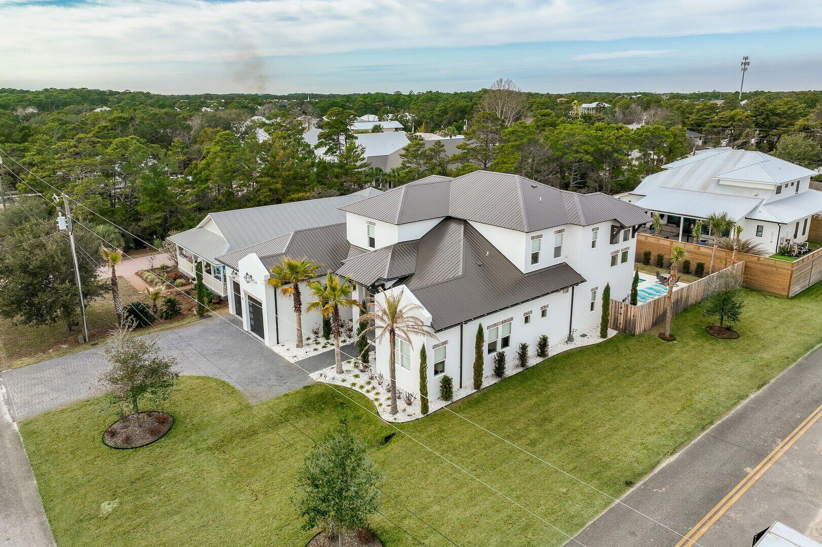 INVESTMENT PROPERTY OPPORTUNITY!! This exquisite TURNKEY home a short stroll to the beach is in the 30A Community of Blue Mountain. From the moment you step inside this beauty, you'll never want to leave. Your eyes will be drawn to the wall of glass doors that open to the outside pool, spa, and entertainment space. Inside is equally amazing with tall ceilings in the living, dining, and kitchen areas giving new meaning to open concept. The kitchen is a chef's dream with an 8-burner gas stove, double ovens, and 2 refrigerators. There is seating at the kitchen island for 6 plus a dining table that seats 8 and an additional bar top area for 3. This is the perfect place for corporate retreats, reunions, multi-family gatherings and much more with room to sleep 20. *Golf cart included*
