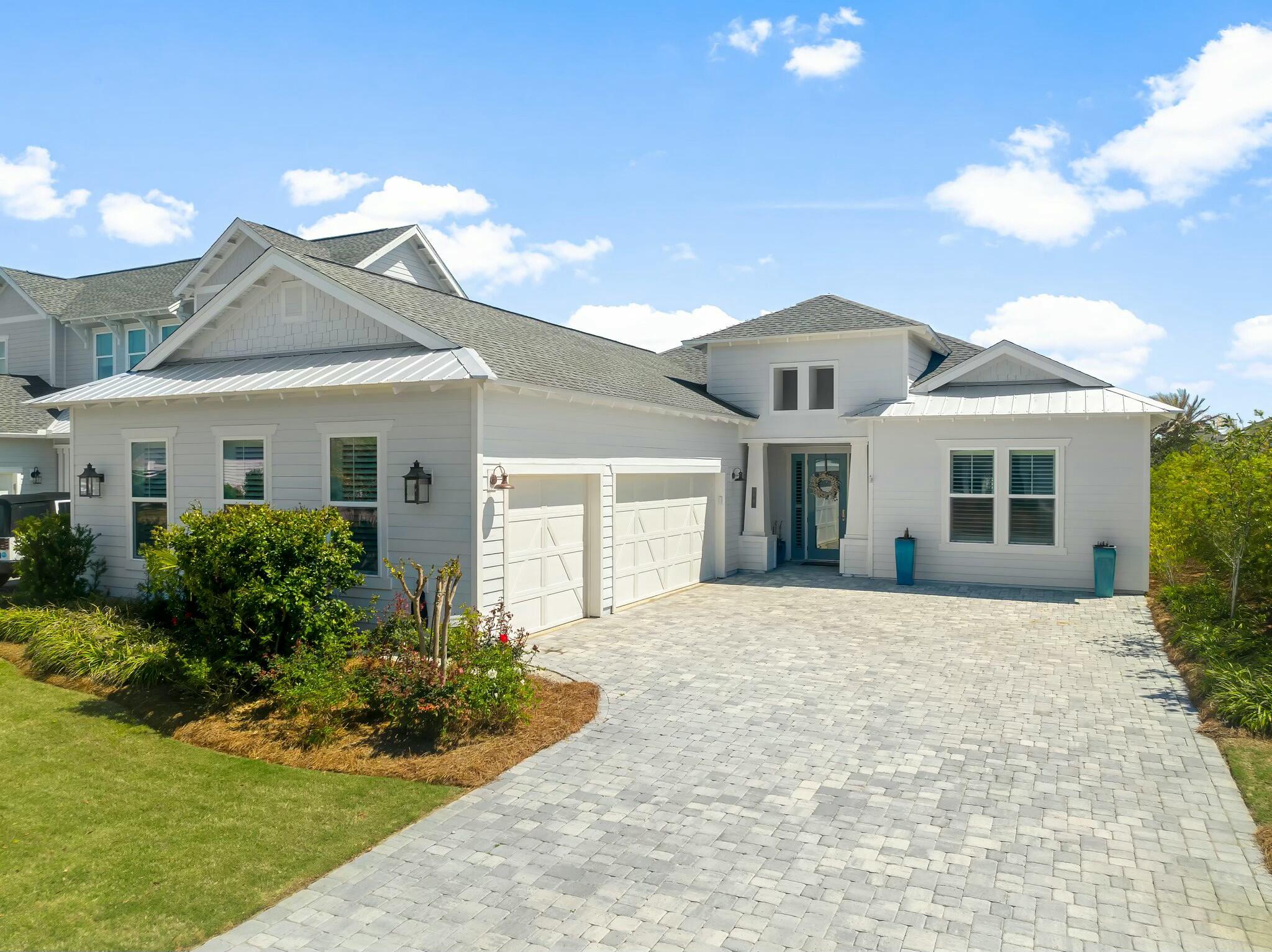 Located in the exclusive gated community of Watersound Naturewalk, this beautifully upgraded single-level home offers luxurious living with 10-foot ceilings, hardwood floors, shiplap accent walls, and custom finishes throughout. The open-concept design features a gourmet kitchen with a gas stovetop, wine fridge, oversized island, and pantry, flowing seamlessly into the spacious living area.
Enjoy the outdoors in your private porch with automatic privacy screens, heated saltwater pool, spa, and firepit — the perfect spot for grilling, relaxing, or watching a game. The primary suite includes a large ensuite with a walk-in shower, soaking tub, and direct access to the pool. Two additional guest rooms, one with an ensuite, provide ample space for family or visitors. The fourth bedroom is currently used as a home office.
Other highlights include custom window treatments, a 3-car garage with attic storage, and a bright laundry room with ample storage. All rooms come with televisions for added convenience.
Enjoy access to golf, pickleball, tennis, community gym, and nature paths within the community. A short bike ride to Alys Beach and Rosemary Beach, with shops, restaurants, and a farmers market nearby.