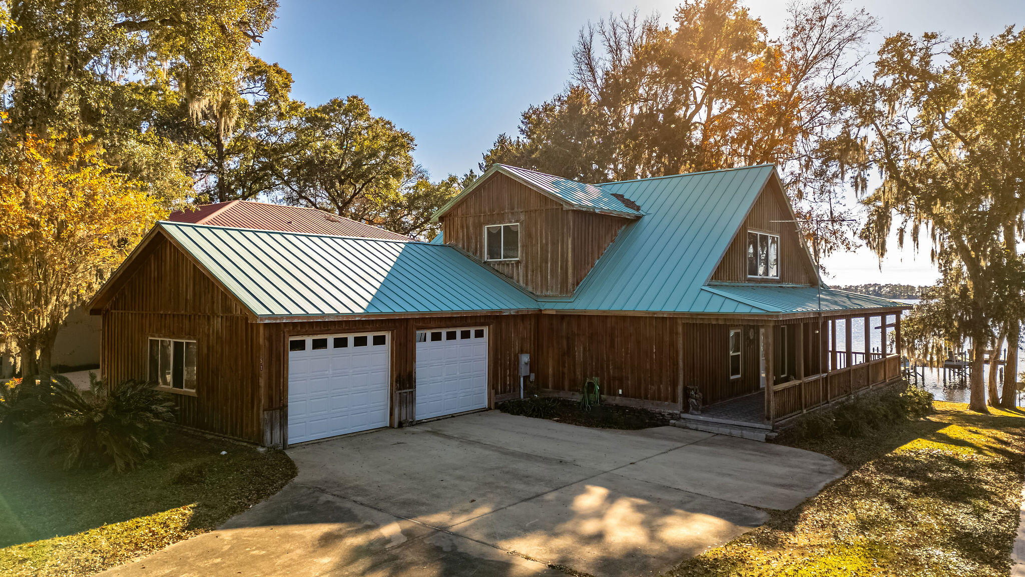 Embrace waterfront living at its finest in Freeport on Alaqua Bayou.  A private boat dock beckons water adventures, while the back porch offers a front-row seat to breathtaking views.
Crafted with love & featuring cypress wood siding, this custom-built haven boasts an open layout that seamlessly connects living, dining, & kitchen spaces.  The primary suite on the 2nd floor, with its patio overlooking the bayou, creates a personal oasis for relaxation.  2 bedrooms with ensuite bathroom downstairs offers comfort.  Home features gas fireplaces, abundant storage, ensuring a clutter-free haven & laundry room with wash sink.  Tucked away on a tranquil cul-de-sac, this residence offers privacy & serenity.  Ready to live the waterfront dream?  Schedule your showing today!