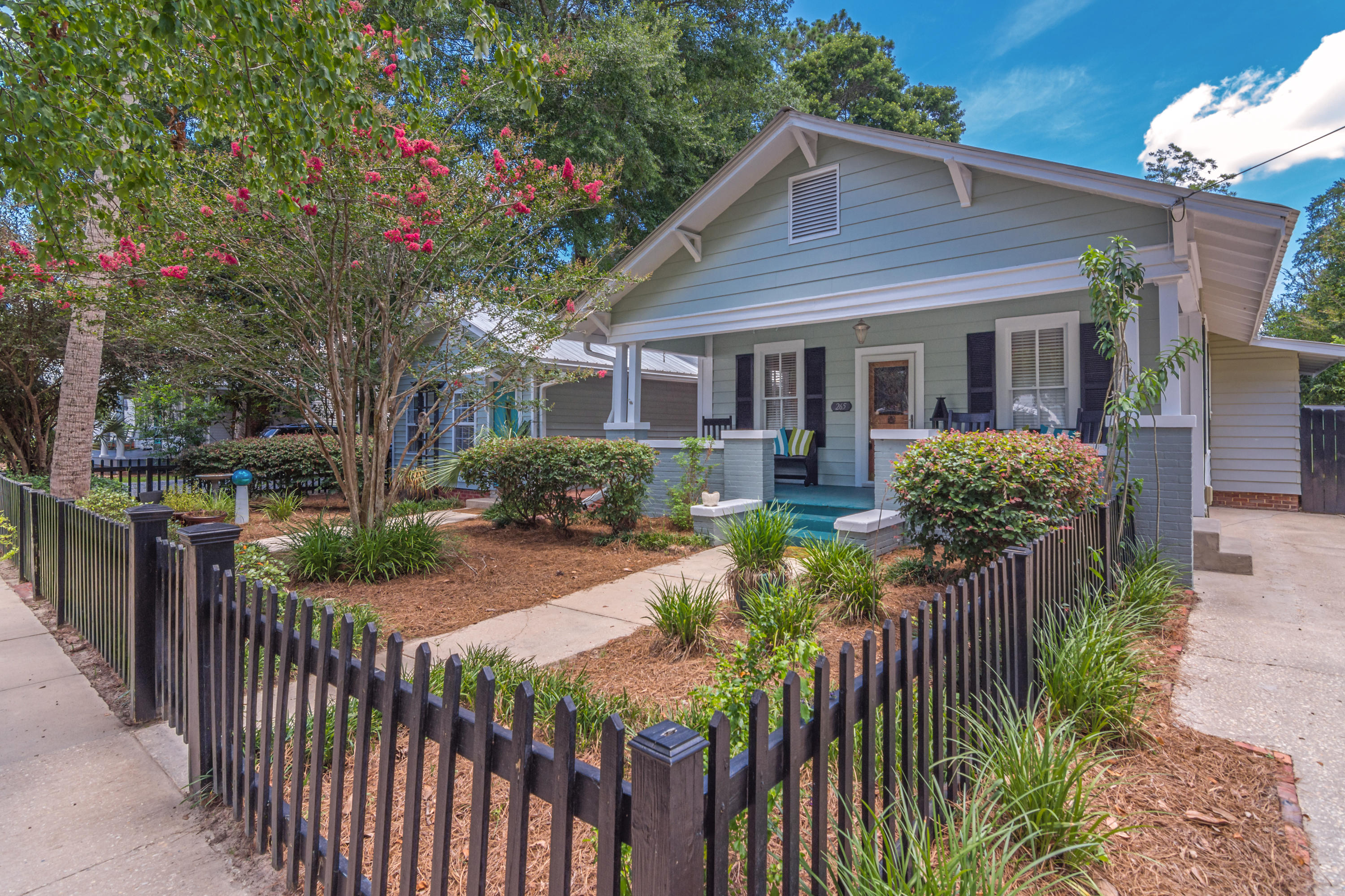 New Price! Dr. Seuss simply asked, ''Why fit in when you were born to stand out?'' Located just blocks from Lake DeFuniak and downtown, this architect reimagined and redesigned, down to the finest detail...historical gem will draw you in, charming you completely. Original details like heart pine floors, tongue & groove walls and ceilings are met with the more recent glorious family room addition and screened porch overlooking the reflection pool (you can't help but picture spending most of your time relaxing in these 2 amazing spaces)! There are 2 homes: main house & guest house; plus, a separate office and separate shed. The main house is 2 beds/2 baths with 1412sf cloaked in soothing, subtle tones of blues, beige, gray and green. From the street, open the gate and perfectly appointed picket fenced front yard to the covered front porch. When you enter, you'll see the incredible quality in detail and how every inch...every nook and cranny was utilized to the fullest. The family room addition with storage closets and views to the porch is the place to be. Step out onto the tiled screened porch overlooking the reflection pool. The 640sf guest house boasts a newly built bedroom addition, kitchenette & walk-in storage. Full bath showcases timeless & elegant carrara subway tile bathtub surround. It could be used for guests, a rental, or would be perfect for someone who needs a professional home office with front entrance. Next is the newer construction 14x20 studio/workshop building with sink and bath (perhaps your new art studio?).The reflection pool is in perfect sightline no matter which structure it's viewed from. The property is completely fenced with 2 double gates at the back alley entrance - don't you love a back alley entrance?! This exquisite property has been on the tour of homes before so it may look familiar...and you'll certainly have to go through at least a couple of times just to see and appreciate the many details that are too numerous to try to list here. With the downtown revitalization and the Main Street program, this is your chance to buy in the coveted historic district of DeFuniak while it is still up and coming. Properties like this do not come along every day, so don't miss your chance and schedule a private showing today!