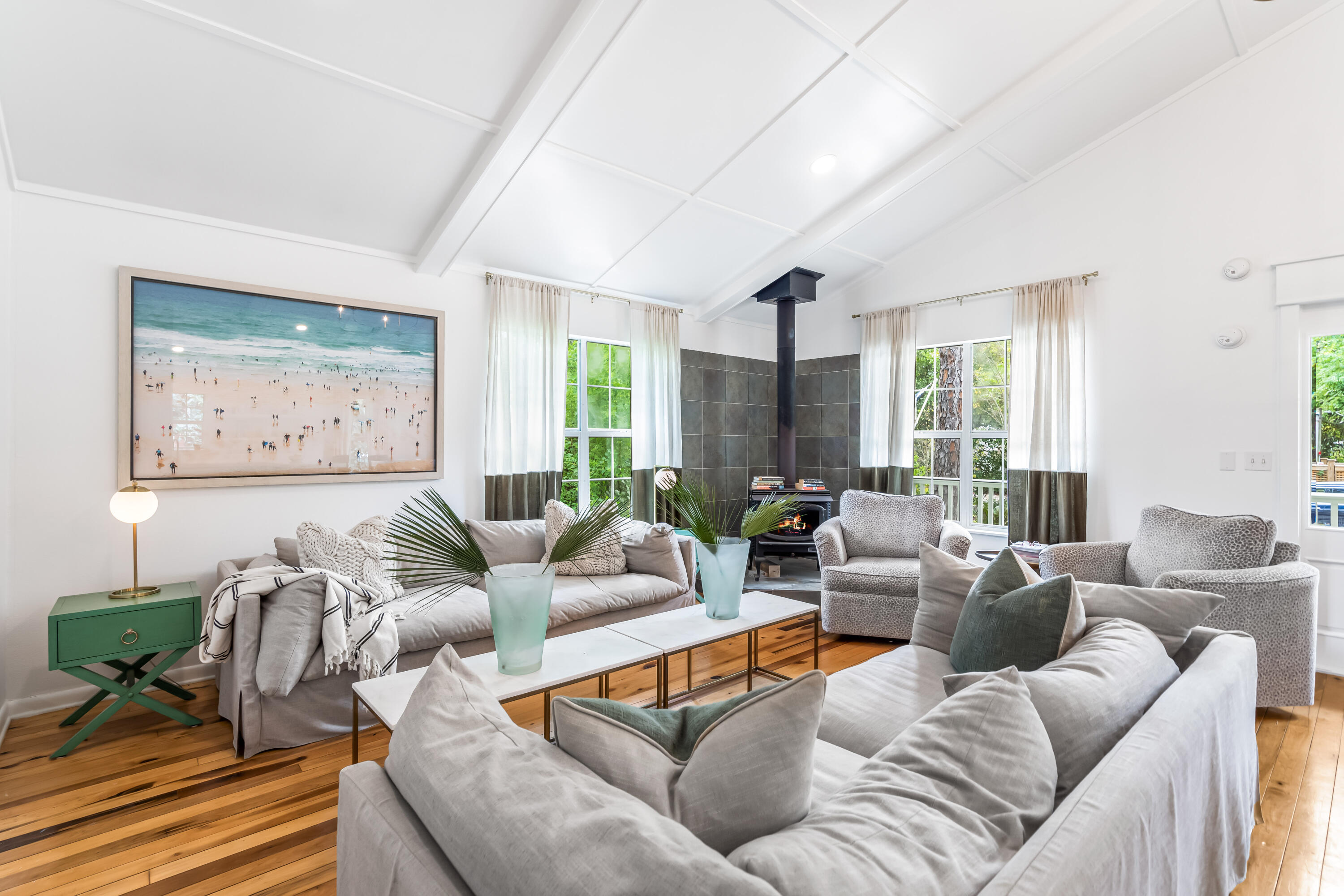 Nestled in the heart of Grayton Beach, this charming cottage on stilts offers the very best of Old Florida living just down the street from the beach. This home features an airy coastal vibe making it the perfect getaway at the beach. Upon entering the home, you're greeted with warm hardwood floors, vaulted ceilings, light-filled bedrooms, and windows which ideally frame the trees around the home. The kitchen features sleek, upgraded appliances, cool green cabinetry, and open-air shelving. Keep cozy in the winter season with a rustic wood-burning fireplace in the living room. Both bathrooms offer bright white walls and light tile, creating a clean, spa-like ambiance. The master bedroom provides access to one of the home's many covered porches, providing the ideal spot to enjoy your morning coffee. In the private backyard, you'll find an extra guest space with two sets of bunk beds, various seating spaces, an outdoor kitchen, and a peaceful pool surrounded by trees. Located under the home near the outdoor entertainment space is a beautiful, full bathroom complete with a shower for guests and an elevated shower for pets providing easy clean-up after your beach days! Ample covered parking is available under the home as well as a driveway. This dreamy cottage perfectly embodies the Grayton Beach spirit and is located minutes from The Red Bar, Chiringo, boutique shopping, beach and lake accesses, trails and much more.