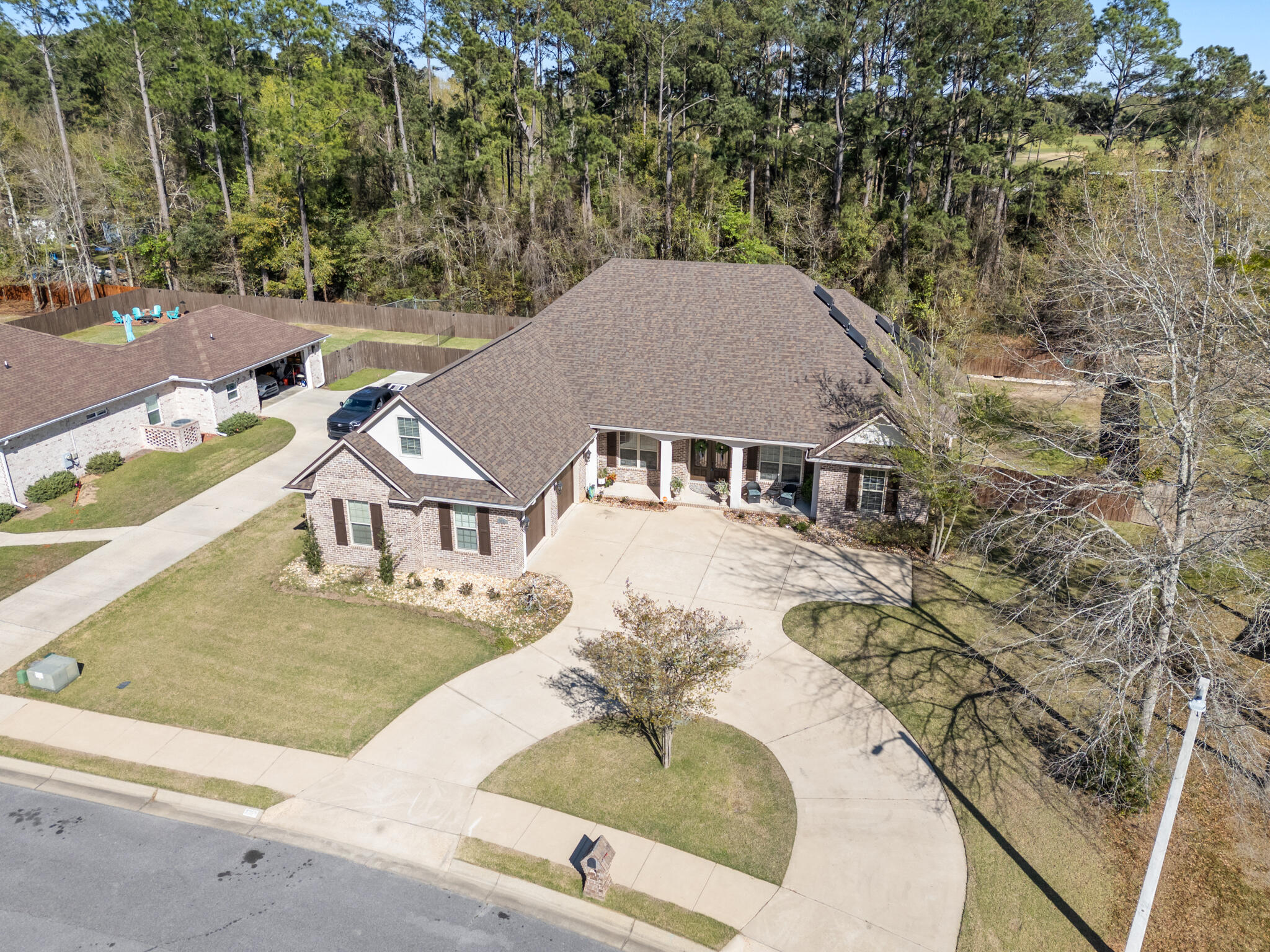 As you enter this thoughtfully designed custom all brick home built in 2014 by Robert Davis, you're welcomed by a dedicated office featuring custom built-ins and a dual workspace, perfect for working from home, followed by a formal dining room ideal for hosting and entertaining. Continuing into the heart of the home, the living room offers a warm and inviting atmosphere with soaring ceilings, custom built-in bookshelves flanking a cozy gas fireplace for added comfort. The kitchen is beautifully appointed with granite countertops, stainless steel appliances, a breakfast bar, and an eat-in dining area that overlooks the pool, creating the perfect space for everyday living and entertaining. Moving through the home, you'll find a well-designed layout that includes a spacious primary suite with two walk-in closets--one featuring a built-in vanity, the bathroom with a seperate tile shower and garden tub for a true relaxing retreat. Additional bedrooms including a private wing with an en-suite bathroom that offers handicap accessibility, making it ideal for multi-generational living or guests. Upstairs, a versatile bonus room with its own HVAC system and private entrance from the garage provides endless possibilities as a teen suite, game room, or guest retreat. Step outside to your private backyard oasis, where a covered saltwater in-ground pool and spa create the perfect setting for relaxing or entertaining year-round. Additional highlights include a 2023 whole-house generator, a large pantry, a separate laundry room with cabinetry and sink, and a 2-car garage with extra storage space and a tiled dog bath. 2025 roof with paid off solar panels! With its thoughtful design, flexible living spaces, and exceptional upgrades, this home is truly a must-see.