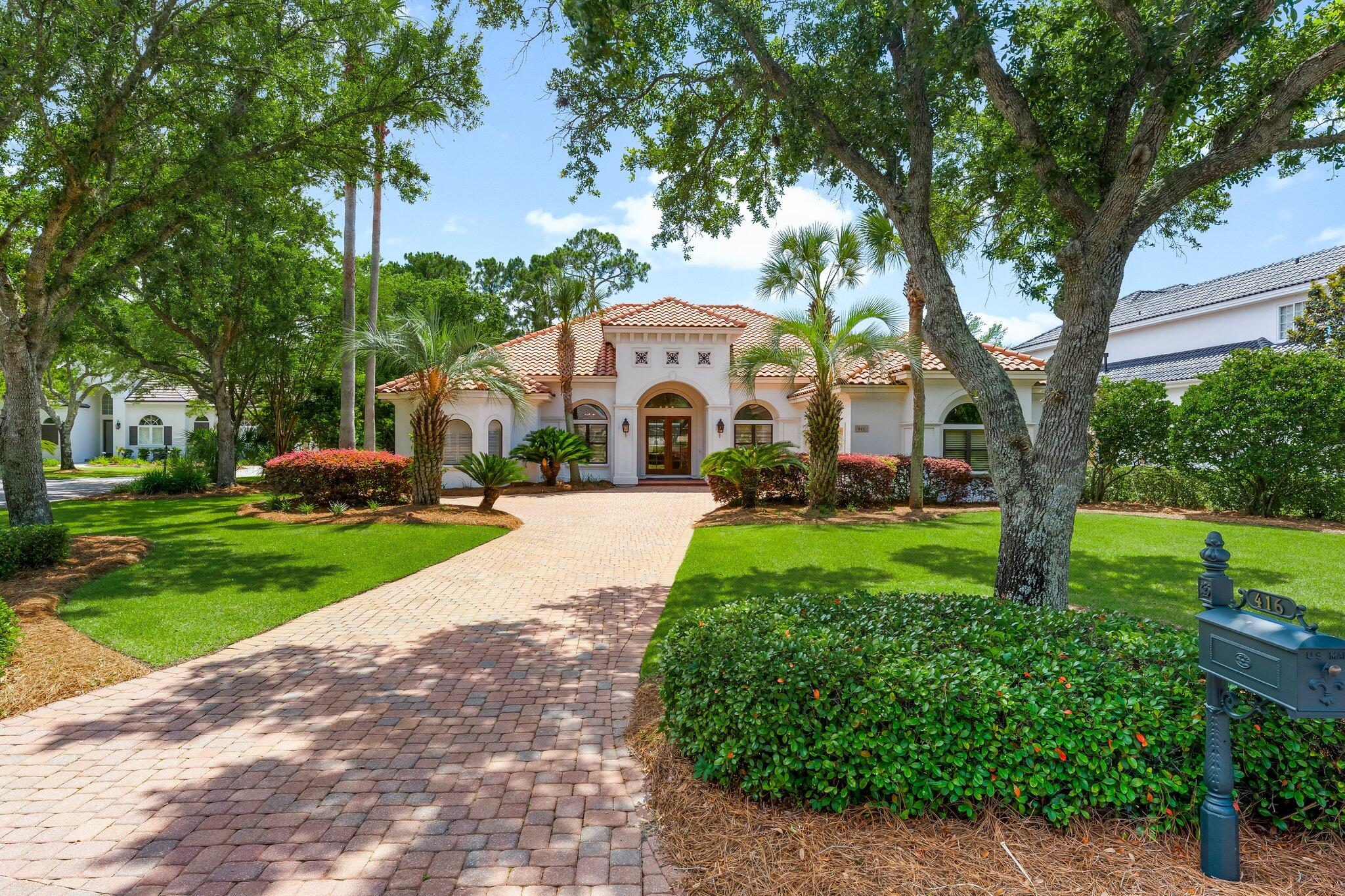 Updated, custom-built home nestled within the highly desirable Commodore Point section of the prestigious Regatta Bay gated community. Situated on a private cul-de-sac lot encompassing a well-manicured yard, this one-story 4 bed/3 bath home blends on-trend design elements in a timeless finish. The exterior has great curb appeal with a paver driveway, gas copper lanterns, mahogany and glass double front doors and recently replaced sod. The interior highlights an abundance of finely appointed architectural details. The foyer boasts soaring 13' ceilings, showcased by travertine floors that extend throughout the home and a straight-line view to the stunning pool area. There are two separate living spaces. The living room has 12' trey ceilings with crown molding, a triple panel, pocketing sliding glass door that opens to the lanai (perfect for entertaining!), shell stone gas fireplace featuring a reclaimed oak wood mantle anchored by built in shelving and cabinets on either side. The family room also has gorgeous built in shelving and cabinets, a sliding glass door to the pool area and engineered hardwood floors. The kitchen is open to the family room and features updated marble countertops, custom built hood vent, island, breakfast bar, spacious pantry, brand new tiled backsplash and newly replaced refrigerator, gas cooktop and dishwasher. There are two separate dining spaces. The formal dining room features a 13' trey ceiling with crown molding and arches. The other dining area off the kitchen offers a spectacular view of the pool area with its large, mitered glass window. The home is a split floor plan connected by a wide and spacious gallery. The master bedroom is a private retreat with a sliding glass door that opens to the pool area, engineered hardwood floors and trey ceiling. The huge spa-like master bathroom delivers quite the wow factor with its trey ceiling, two separate vanities, expansive walk-in shower, large soaking tub, two separate walk-in closets, linen closet, built in dressing mirror and water closet. The 2nd and 3rd bedrooms share a dual access bathroom. The 4th bedroom is currently used as a study and there is a full bathroom across the hall which has an exterior door to the pool area. All bathrooms have brand new marble countertops. Lush, mature landscaping surrounds the backyard offering privacy for the pool area which features new shell stone pavers, new screens on the pool cage and a new pool pump. The laundry room has updated marble countertops, upper and lower cabinets and new washer and dryer. Both water heaters were replaced in July 2025. Regatta Bay is the epitome of convenience and homeowners enjoy the finest of amenities including the award-winning golf course, beautiful clubhouse with top notch restaurant, community pool, tennis, pickleball, playground, miles of walking paths and security. Hop on your golf cart to the Destin Commons, Whole Foods, LuLu's restaurant and the marina along the picturesque Choctawhatchee Bay.