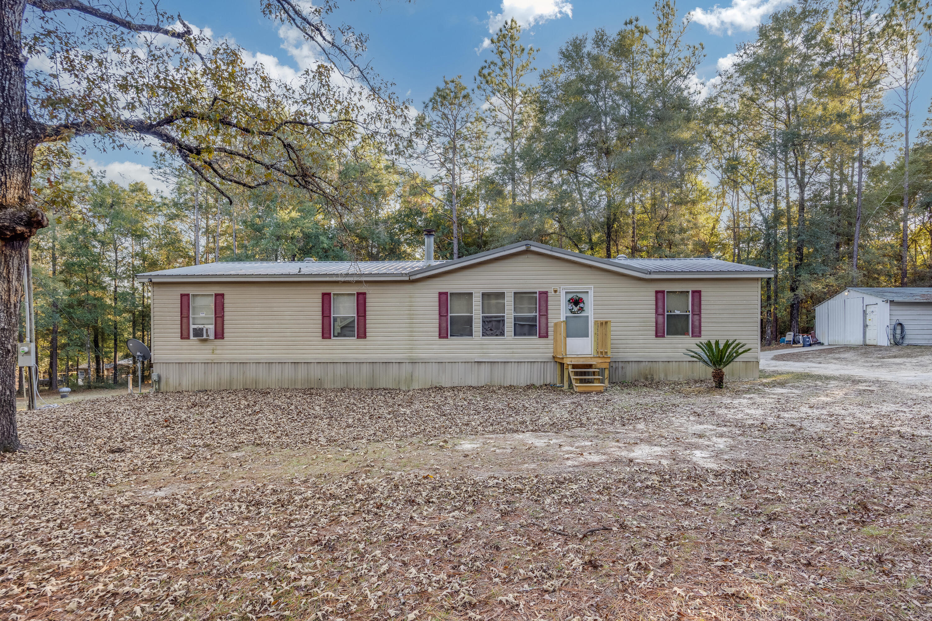 SELLERS OFFERING TO PAY BUYERS CLOSING COSTS!!!!! Check out this perfect starter home set up, located in the highly sought after Baker area! Resting on almost a full acre, including a metal work shop with power! Step into this charming 3 bedroom, 2 bathroom home, offering new vinyl flooring throughout and a open floor plan for all your entertaining needs! Very spacious kitchen with ample amounts of storage, beautiful light stained cabinetry! Also including a wood burning stove in the living room! Very large master bedroom, along with a double vanity sink and his and hers walk in closets! Good size spare bedrooms as well. To the back of the home you are greeted by a large covered back porch, following around to the large metal workshop! Come and see what all this home has to offer the new potential owners!