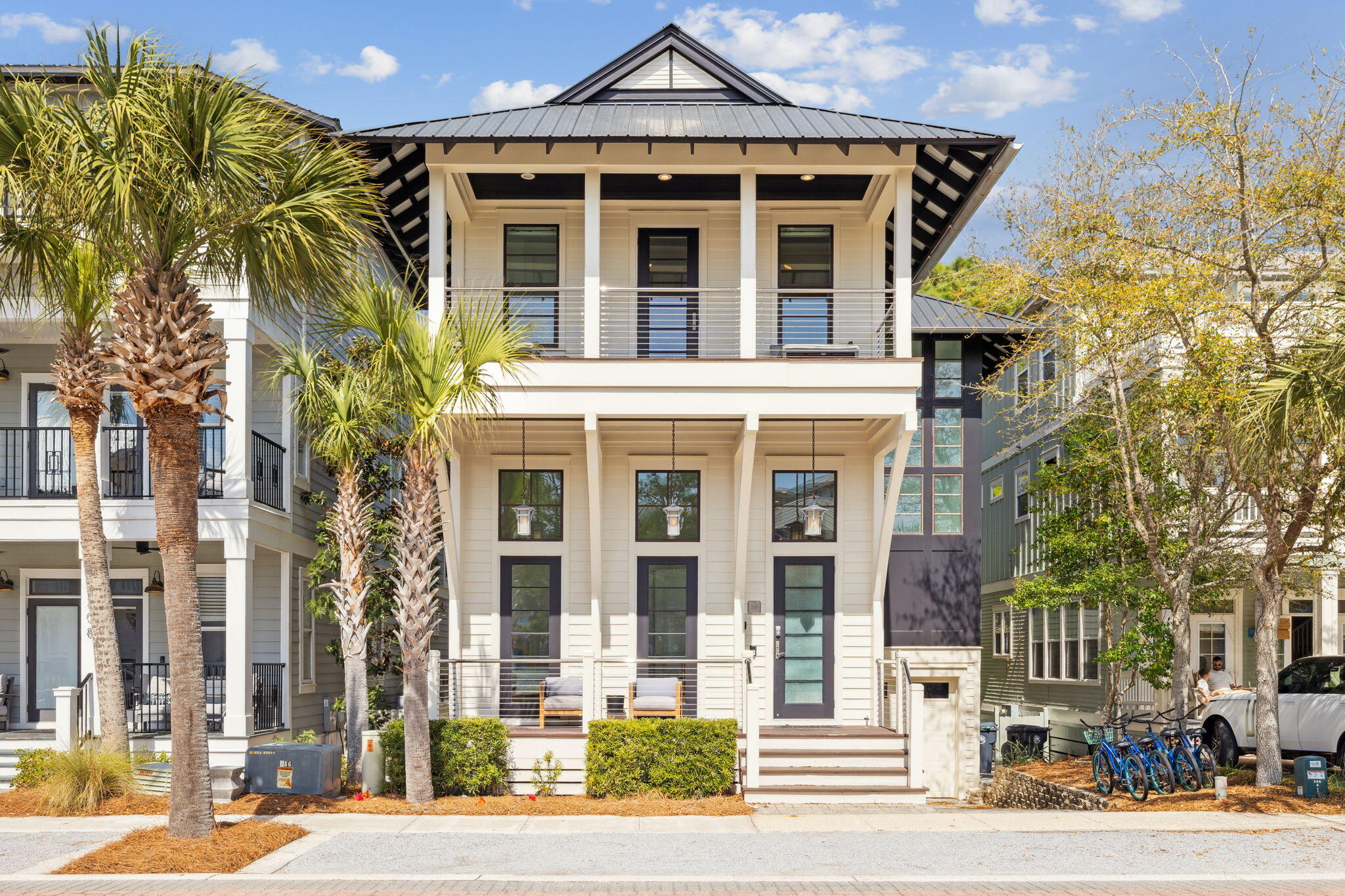 This stunning 30A dream home has been custom-built to host an extraordinary experience at the beach. Conveying fully-furnished, this exceptional getaway can be a lucrative investment property with rental projections at $150K annually. Located in the heart of Seacrest Beach, this property presents a wonderful floor plan with five bedrooms, a home gym, two separate living rooms and multiple levels of outdoor living spaces. This beautifully designed home flaunts a summer kitchen on the first floor, luxury pizza oven on the second floor balcony, and gas fireplace on the third floor balcony. The meticulously-curated interior has hardwood floors, large transom windows and unique floating stairs. The well-appointed chef's kitchen is equipped with double Fisher Paykel refrigerators, durable granite countertops, a 48 inch Thermador gas range, and an oversized pantry. The main living room showcases nano doors leading out to a rare two-story atrium. The living room is furnished with modern seating along with a beautiful fireplace and wood mantel. The entrance to the home displays an airy foyer which is adjacent to a primary bedroom with an ensuite bathroom. The ground level features a massive guest bedroom, custom built-in bunk beds and a gorgeous home gym filled with natural light. This ground level has a spacious living room with access to the screened-in summer kitchen. The top floor has two primary suites with vaulted ceilings, a fully-equipped laundry room and a breathtaking screened-in balcony. The home is offered fully-furnished and rental-ready. Inquire to receive rental income information and estimated expenses for this Seacrest Beach dream escape!