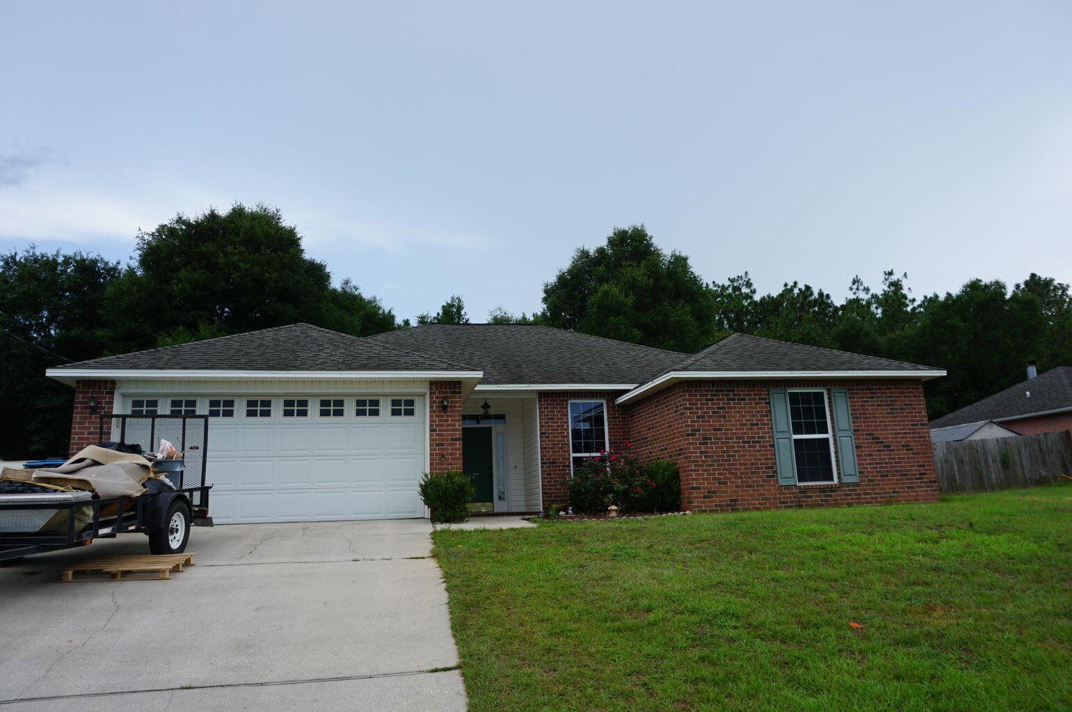 Available 07/28/2021...South Crestview home, 14 minutes to SFC and 25 minutes to Eglin AFB features large living and large lot. 3/2 with 1677 square feet of living space featuring newer ceramic tile floors, newer paint, split floor plan and convenient to beaches and shopping. Large lot gives added privacy in the back yard backing up to a wooded area. Privacy fenced and screened back porch for Florida sunsets. Great curb appeal invites you in to a foyer and large living room with fireplace. Eat in dining area and spacious kitchen boasts neutral paint and tile flooring. Large laundry and additional bedrooms offer space for larger furniture. The master is spacious and can accommodate KING size furniture. The master bath has plenty of room and walk in closet. 2 car garage & more.