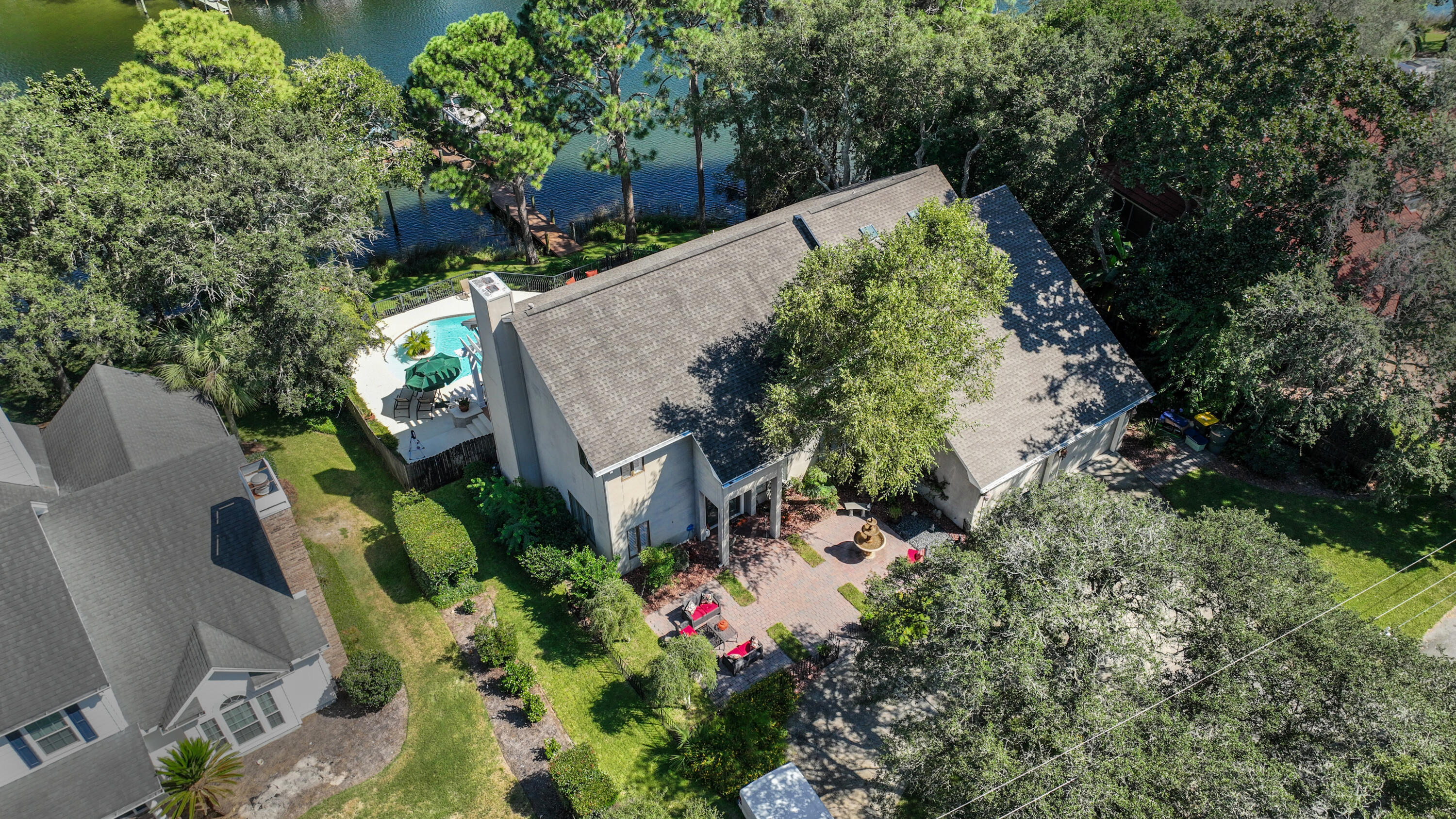 This gorgeous waterfront family home with a backyard oasis is located on Cinco Bayou in Fort Walton Beach. The exquisitely maintained home features an open floor plan with the spacious living area opening to the kitchen and breakfast dining area. A guest bedroom and bath and a laundry room are located on the first floor, as well as an office with custom built-ins. The master suite has a sitting area, fireplace, and private balcony. The second floor includes an open loft area, a bonus room, a bedroom suite, and another  bedroom and hall bath. The two car garage allows for plenty of storage. The lush backyard includes a pool, beautifully manicured lawn, grilling area, and plenty of space to entertain. The dock has a boat lift and waterslide for ideal coastal living. Welcome to paradise!