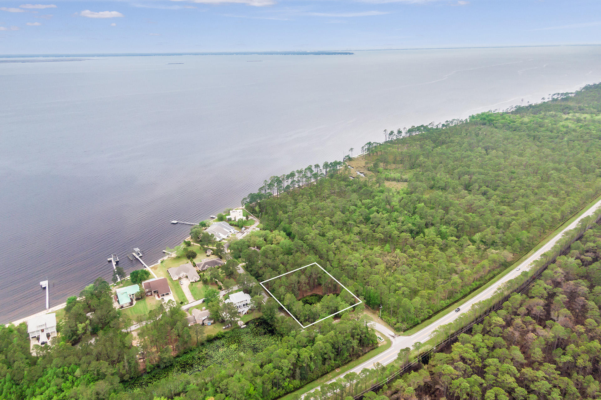 Wooded lot with tranquil pond view, available in Dolphin Cove Estates. This lot is perfect for building your dream home. Just a short drive from Bluewater Bay, Niceville, and the gorgeous white sand beaches in Destin.
