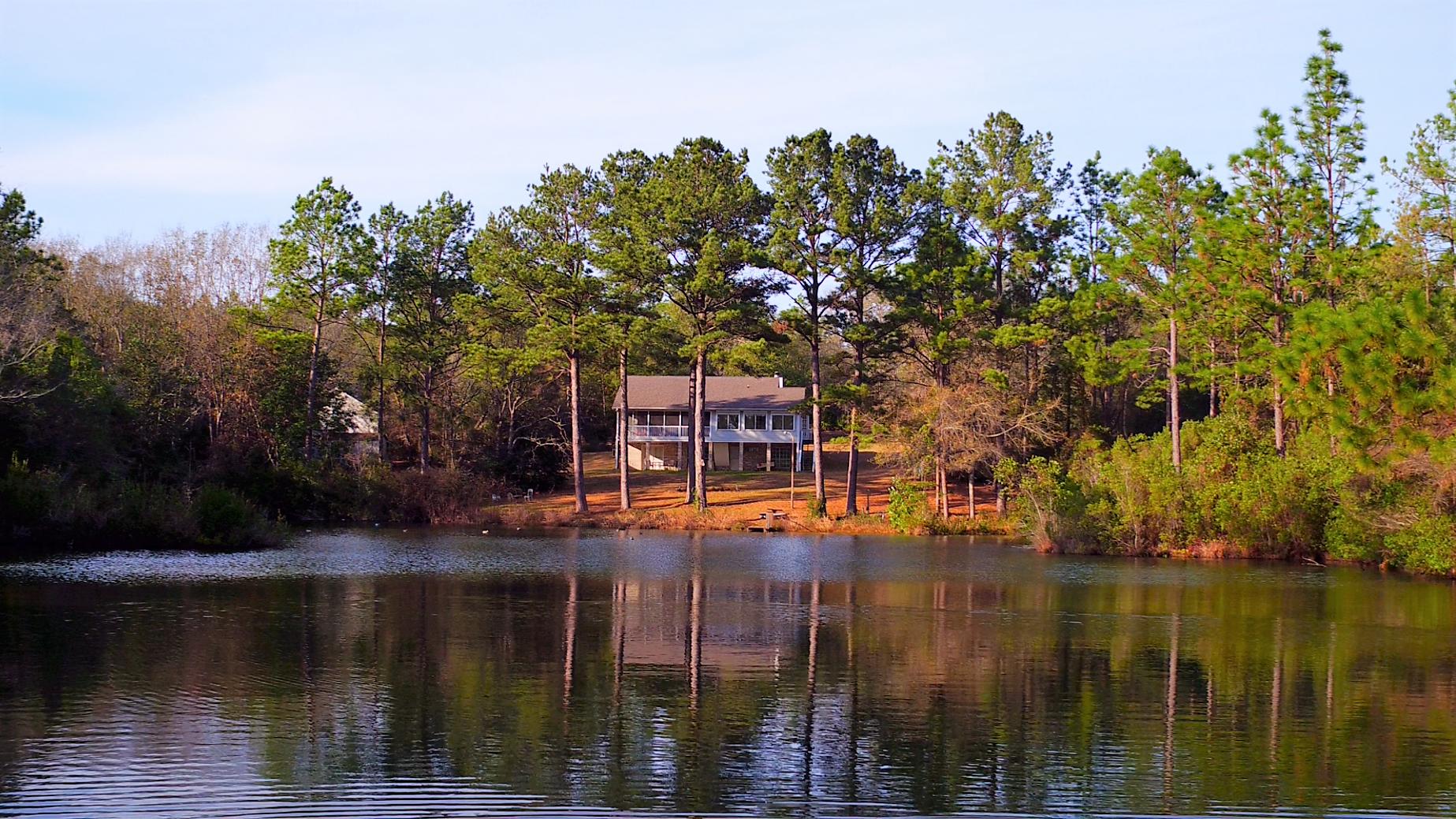 Bring your ATVs and Fishing Poles! Amazing VIEWS of 24+/- Acres and TWO Acre POND from your 5 Bedroom Home! Conveniently located off of Airport Road near the schools, grocery stores and restaurants! Enjoy living on your own wooded acreage to roam and FISH from your OWN Pond..PLUS a trail along the entire property line. Tranquil setting is great place to relax and enjoy LIFE. Two additional buildings include a workshop w/power and plumbed; and a shed w/power. Main Floor of Home overlooks the pond w/Master Suite, 2 Bedrooms, Full Bathroom, Sun Room, Living Room w/Fireplace, Kitchen, Dining Room, and a HUGE Screened Porch. Finished Walk-Out Basement has 2 additional bedrooms, Full Bathroom, Office, and storage space. Extensive use of tray ceilings and arched doorways. Home Warranty provided. American Home Shield Home Warranty value of $400. Please verify zoning, school zones, and any other information that is important to you. TWO parcels are: 25-4N-23-0000-0015-010A & 25-4N-23-0000-0015-0100 with the SW 2.7 acres not included in the sale.