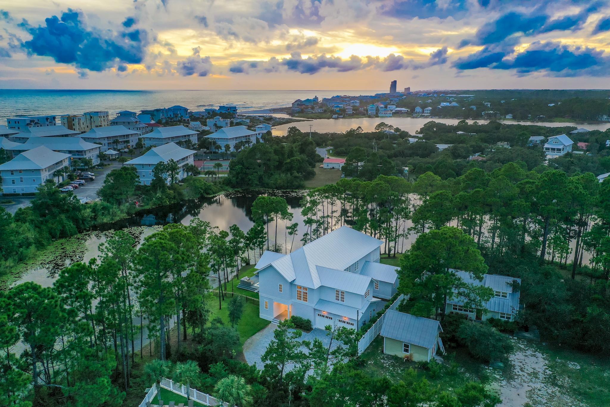 Phenomenal fully furnished 6-bedroom, 6.5-bath lakefront home boasting 4,753 sq ft & 2-car garage located in the heart of 30A with no HOA fees! This home is positioned at the end of the street on Lake Tresca, offering tranquility & the luxury of privacy. Nestled between Eastern Lake & Deer Lake, the home is surrounded by natural beauty & pines. Just a short walk, bike, or golf cart ride away from having your toes in the sugar-white sand along the emerald green & crystal blue waters of the Gulf of Mexico! Walton Dunes Beach Access is just 1/2 a mile away & Eastern Lake Beach Access is only a mile away. Enjoy coastal living with incredible outdoor spaces including the large pool overlooking the lake, hot tub deck, wraparound balcony with gas grill & stunning views, and paver stone courtyard. This home offers stunning finishes including hardwood oak flooring throughout with tile in the bathrooms, Quartz countertops, tongue & groove ceilings, beautiful chandeliers, waterfall edge island, state of the art appliances and vaulted ceilings at the entry and main living area. You truly feel at ease in this home and the flow of the house is well thought out. There are two master suites, two living areas, and majority of the bedrooms have beautiful en-suite bathrooms and walk-in closets with custom shelving and drawers. The attention to detail and pride of ownership is superb. The first level features a spacious living area, kitchenette, master suite, & 3 additional bedrooms each with an en-suite bathrooms. One set of French doors leads out onto the oversized covered deck and pool area, while the other set leads out onto a charming open patio courtyard made with lovely paver stones.

The second level features an open living & dining area, elegant kitchen, generous master suite with en-suite bath, bunk room, full bathroom & a large wrap-around entertainment deck. The covered deck is great for grilling & dining outdoors with plentiful seating to relax in and take in the lake views and serene settings. Facing west, the sunsets are incredible over the lake and pool area. The back yard has nice options for unwinding such as cooling off with a dip in the sparkling lakefront pool or relaxing in a hammock down by the beautiful lake. The second level greets you with a vaulted wood plank ceiling & contemporary lighting. Several windows & French doors allow in plenty of natural light giving the area a vibrant & refreshing ambiance. The great room features a fireplace & gorgeous chandelier. The open dining area is spacious with plenty of room at the table for family & friends. The large breakfast bar is great for causal dining or overflow seating if needed. Gorgeous kitchen features a marble island with a farmhouse sink, marble counters, contemporary lighting, custom backsplash, ample cabinets, & stainless steel appliances. The open floor plan makes entertaining easy! The wrap-around entertainment deck is perfect for outdoor dining, watching the sunset, or cheering on your favorite sports team. Serene views of the lake & pool area can be observed from the upper deck.

Both master bedrooms offer lovely furniture & decor as well as an en suite luxurious master bath featuring double vanities with marble countertop, walk-in tile showers with rain shower heads, & beautiful tile floors. All 4 additional bedrooms are generous in size & feature en suite bathrooms, with the exception of the bunk room. The laundry room is located on the first level & features a full size washer/dryer & ample cabinets for storage. Parking is never an issue at this home with a lovely oversized paver stone driveway & 2-car garage. Stunning architecture is apparent both inside & outside the home.

Located in the heart of 30A, this home is approximately 2 miles from Seaside & 2 miles from the HUB. Entertainment, shopping & dining are a short bike ride or walk away! Eastern Lake public park is just around the corner & offers a boat ramp & is great for paddle boarding, kayaking, boating, etc. Don't miss this amazing opportunity to own such a beautiful home in such a desirable location!