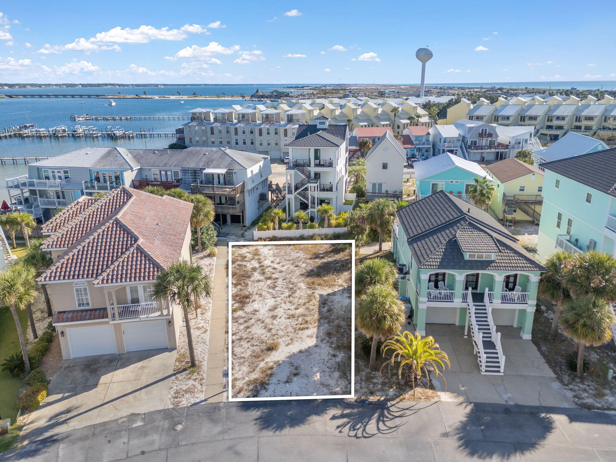 Survey Complete, GeoTech Soil Test Complete. Welcome to The Village at Navarre! One of the most sought-after communities on Navarre Beach, this private waterfront neighborhood offers the perfect blend of coastal charm and convenience. Ideally located on the Sound Side, you're just a short walk from the sugary white sands of the Gulf of America and moments from local dining, shopping, and beachside events. The Village at Navarre has no rental restrictions, making it ideal for a full-time residence, vacation getaway, or high-performing short-term rental. Community amenities include a sparkling pool, private beach on the Sound, and a newly rebuilt dock and pier equipped with power, water, and a fish-cleaning station.  Enjoy peaceful waterfront living and endless sunsets in one of Navarre Beach's most desirable settings, the perfect place to build your dream home or rental investment property!