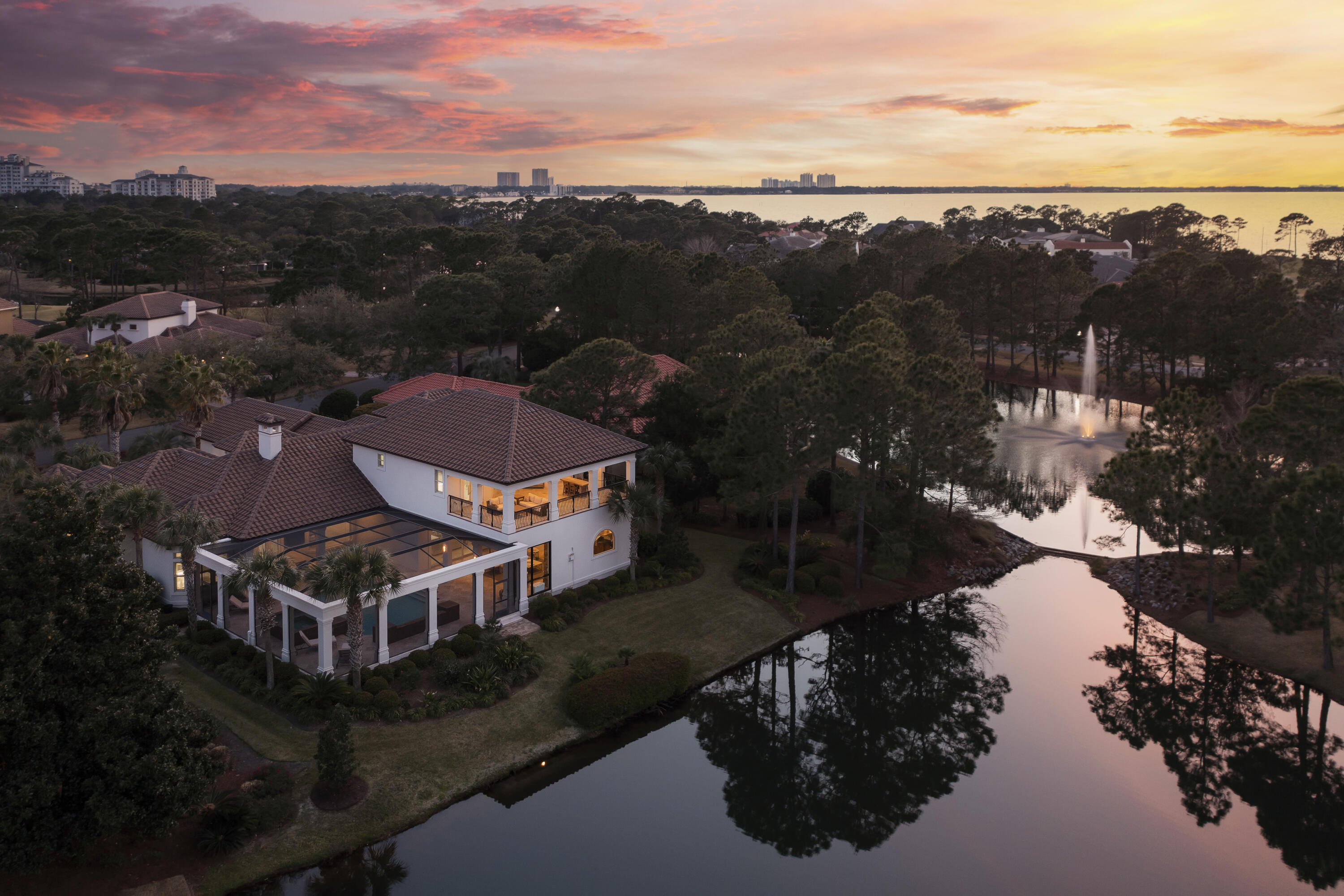 This gorgeous lakefront home located in the exclusive gated community of Burnt Pine, in Sandestin's Golf and Beach resort, was fully remodeled and renovated with high end finishes in 2021-2022. Exquisite detail and craftsmanship complement this beautifully designed villa with soaring ceilings. You'll find it is perfect for both family life and for entertaining in the most beautiful style. A private master wing, a separate guest suite, an office and spacious living areas are on the first floor.  Enjoy the temperature-controlled wine cellar with your family and guests. The indoor and outdoor living areas flow seamlessly together, and you will experience the best of Florida resort-style entertaining in the outdoor living space, which includes a summer kitchen and stone fireplace Outdoor living on the first floor includes a pool and hot tub, an outdoor living area with a gas fireplace, an outdoor kitchen with gas grill, refrigerator and wine cooler, outdoor air conditioners for cooling and four outdoor TVs. There is a collapsible/retractable sliding glass door connecting the indoor and outdoors living areas.

On the second floor, there are two more bedroom with en suite bathrooms, along with an additional living area and wet bar, with a considerable deck. Revel in the in the views of both the lake and the golf course!

The extensive remodel includes the following and more: In 2021, the grand foyer was remodeled and painted with a new chandelier by Visual Comfort. All of the bedrooms were remodeled. The master bedroom includes Louvered wood blinds and custom curtains and a complete bathroom renovation. Five bathrooms were completely refinished, with four of those including new tile and wallpaper by Schumacher and Phillip Jeffries, high end plumbing fixtures, showers, commodes, cabinetry hardware and new lighting. The kitchen has been refinished including new Venus Stone counter tops, cabinet hardware, light fixtures and painting, plus a new ice maker. The dining room update with new wallpaper, chandelier and paint. Appliances in the kitchen include a Thermador refrigerator, Thermador freezer, DCS gas range and oven, Scotsman soft ice ice maker, built in microwave, new chandelier by Visual Comfort, and new kitchen countertops made of Venus Stone, along with new custom cabinet hardware, with all of the cabinets refinished and painted white. The wine cellar was updated with new marble and tile and refinished wood trim.  New upstairs HVAC in fall of 2021. Contact us for a full list of the extensive renovation including brands and finishes.