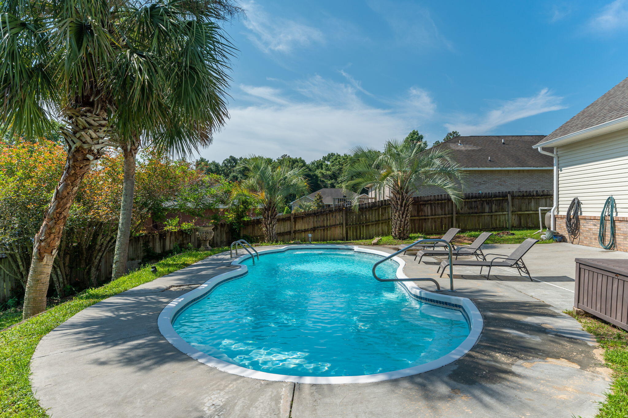 Pool home in central Crestview that is SO Clean! Imagine afternoons on the expansive deck overlooking the sparkling blue waters of your own pool.  Backing up to green space, with additional concrete decking around the pool, afternoons are perfect for sunning and entertaining.  Finish the evening under the twinkling lights of the covered patio. Inside you will find perfection everywhere.  Kitchen is an entertainers dream with spacious open concept, eat-in areas, and ample countertops. Newer appliances, and tile floors make the kitchen low maintenance-come home and RELAX! Bedrooms are huge, and feature new carpet and upgraded padding for quiet sleep. Roof is 2021, Water heater is 2018