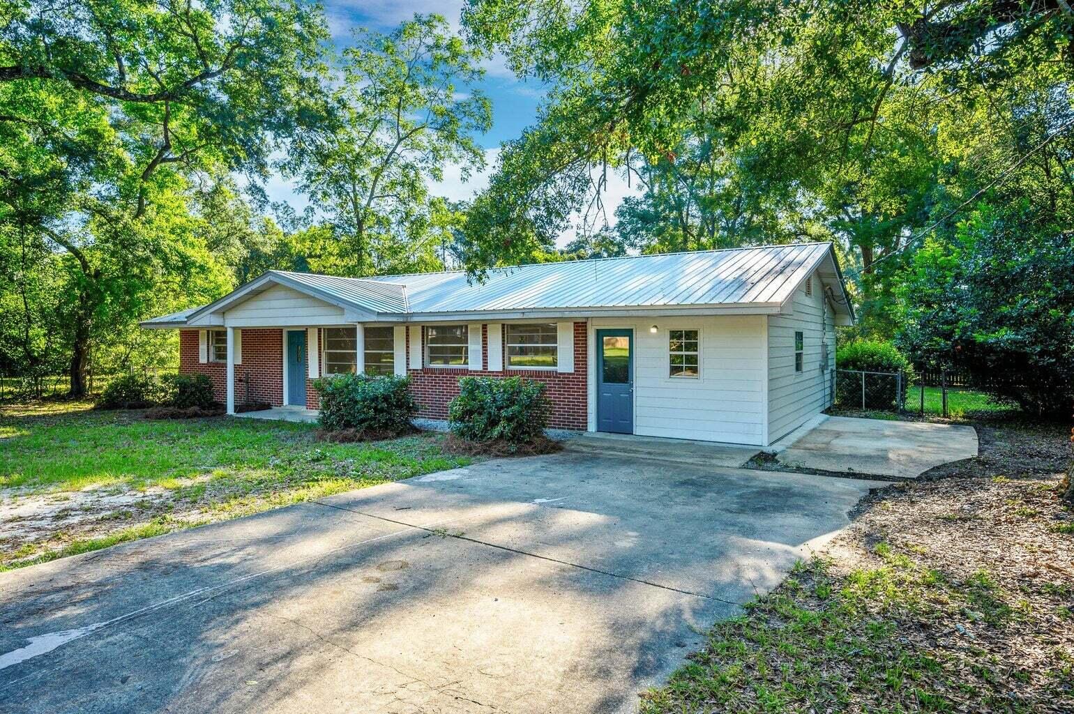 Experience the epitome of comfortable living in our meticulously renovated brick one-story home in the heart of DeFuniak Springs, Florida. This charming residence boasts four spacious bedrooms, two luxurious bathrooms offering ample space for your family's needs. Situated on over half an acre of fenced lush land, enjoy the serenity of nature right at your doorstep. Immerse yourself in the rich history of the area with the historic district just a stone's throw away. With modern amenities seamlessly blended with classic charm, this rental property is your perfect retreat. Welcome home. Requirements include credit score must be at or above 600, income must be 2.5 times the rental amount, & you must have one year on the job. Pets can be approved on a case-by-case basis.