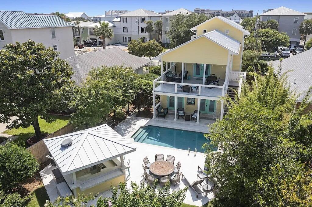 DREAMS ARE MADE OF THIS! ''Good Day Sunshine'', is situated half a block from the sugar white sands and emerald waters of Crystal Beach, this elegant coastal five bedroom, three and a half bath residence is tastefully updated, landscaped, and poised to become a new primary or secondary home, with exceptional rental income.  The first-floor features low maintenance travertine floors with four bedrooms and two shared baths, with two bedrooms opening onto the pool area and a one car garage. On the second floor is an oversized living room with hand-milled walnut flooring, vaulted ceilings that open into an impressive chef's kitchen. The commercial-grade luxury kitchen with custom cabinetry has durable granite countertops, two Sub-Zero refrigerators, a large Wolf gas range and a wine fridge. French doors from the living area lead to an oversized covered porch.  There Is also a Sonus sound system which conveys.
The third floor features an owner's suite with an oversized bathroom, and gulf views from the private third floor master balcony.  There Is also a sleeping alcove off the bathroom.  The master suite is a true escape, complete with his and hers closets, a soaking tub and separate shower.  Desirable exterior features include an extra-deep lot, heated pool, outdoor bar pagoda for entertaining, and a lush side courtyard with a soothing fountain. Italian limestone, all with total privacy and lush landscaping.
Rinse off the sand after a day at the beach In the outdoor, privately enclosed shower. If you appreciate exquisite detail you will love this house!