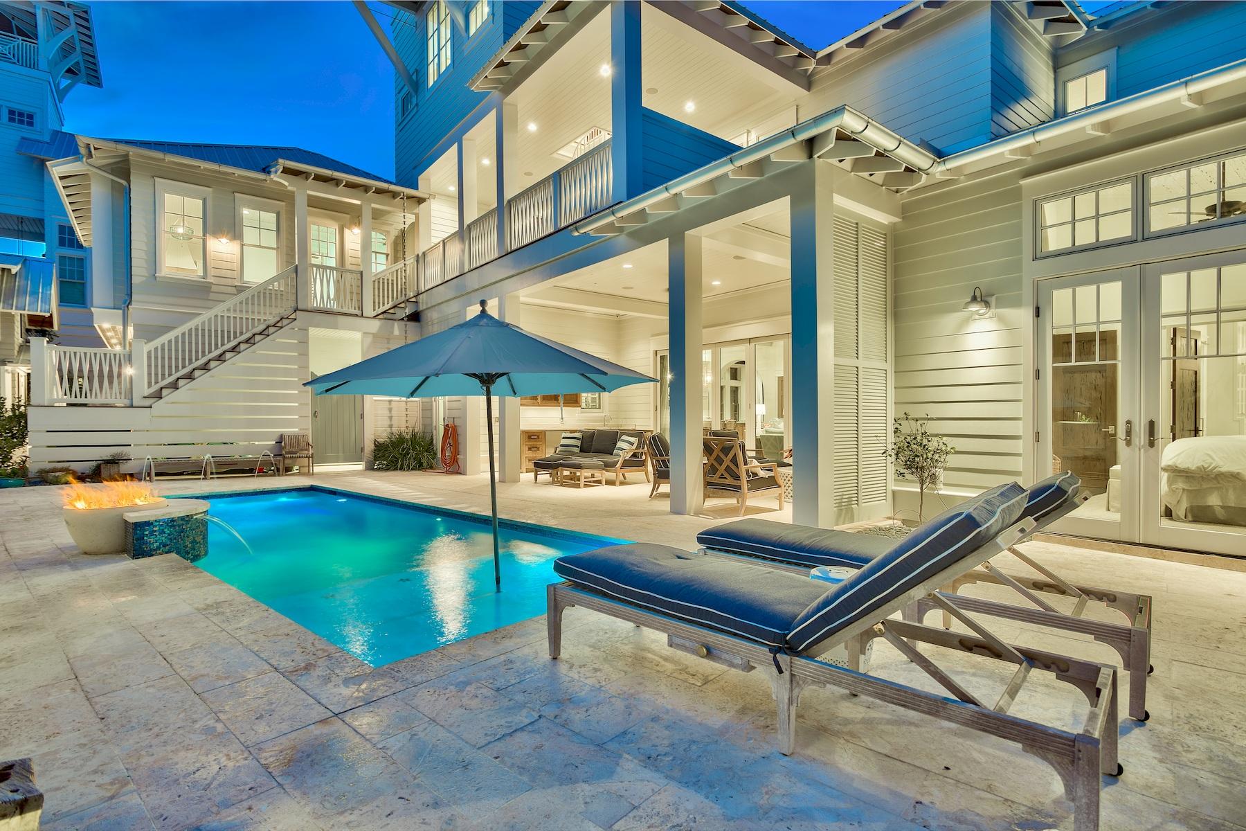 Exemplary coastal design juxtaposed ample privacy characterize this extraordinary beach side retreat ideally located in the heart of Old Seagrove within excellent proximity to beach access and centered between the neighboring communities of Seaside & Watercolor. Situated on an oversized quarter-acre lot, this beautiful custom-built home is finely appointed with professional interiors & decor curated by Alex & Cynthia Rice of Old Seagrove Homes. This elegant compound is comprised of six bedrooms & six and a half bathrooms including an attached carriage house outfitted with a full kitchen, living room, king suite and ensuite bathroom. Extreme attention to detail was taken while crafting this artisan home which exudes sophistication and style with notable features including a private elevator for access to 4 vertical levels, locally milled civil war era pecky cypress ceilings and accent walls, oversized two car garage and a white-washed courtyard surrounded by concrete privacy walls interlaced with planter boxes filled with a beautiful assemblage of coastal plant varieties that provide perfect contrast in the tranquil outdoor living area. This exceptional open floorplan provides a perfect balance of indoor and outdoor living maximizing the primary level of the home. The entry foyer is defined by natural light with floor to ceiling windows and ample space for storage. There is a study and in-home library that is currently utilized as an office space just off the entry foyer. The spacious first floor living room is characterized by a tabby shell gas fireplace, soaring beamed ceilings juxtaposed pecky cypress accents and is open to the chef's kitchen which is anchored by an impressive oversized island complete with a single slab of quartzite, hand built by local craftsmen out of aged cypress. The Wolf range is accentuated by a custom built cypress hood flanked by two windows to let in ample natural light as well as showcasing the hand crafted tile backsplash imported from New York City. The professional grade kitchen also features a SubZero refrigerator and stainless appliances. The living room and kitchen area flow seamlessly out to the rear patio and subsequent courtyard accessible through expansive floor-to-ceiling glass accordion doors allowing easy indoor/outdoor living. The courtyard is centered around a beautiful salt water pool complete with laminar jets and a gas fire feature. The gorgeous outdoor space also offers a fully equipped outdoor kitchen and bar complete with a gas grilling area and a brand new green egg. The master suite is located on the first level with easy access to the outdoor courtyard and pool area; it featured light, coastal colors including a white washed pecky cypress ceiling, sprawling ensuite master bathroom highlighted by floor to ceiling calcutta marble, dual vanities, oversized soaking tub, walk-in shower, water closet and a spacious walk-in closet complete with a stacked washer-dryer combo. 

The second level is well defined by beautiful pecky cypress wainscoting in the stairwell and offers four bedroom suites each featuring complete ensuite bathrooms fully equipped with luxurious marble tile and quartzite countertops as well as ample closet space. There is a second floor living room and fully stocked wet bar that leads out to an expansive oversized covered porch space. The carriage house is accessible on the second floor and also features it's own private entry with private access point. The third floor is accessible by elevator and spiral staircase and is defined by a heated and cooled fitness room/flexible living space. The fourth level is a soaring tower offering beautiful gulf views while presiding over the southern facing elevation which allows a western sunset view corridor towards Seaside. This heated and cooled space is accessible both by stairs and private elevator and is complete with a wet bar and spacious living room to soak in the panoramic orientation. 

Other notable features include a separate, custom built and architecturally significant year structure tucked away in the courtyard and could be defined as a kids playhouse, private art studio or additional space for storage. Seagrove Village is perfectly located in the heart of Seagrove Beach central to all of the new urbanism communities on 30A while being a golf cart ride away from Seaside, Watercolor and all of the subsequent world class shopping, dining and entertainment that these family friendly communities are known for.