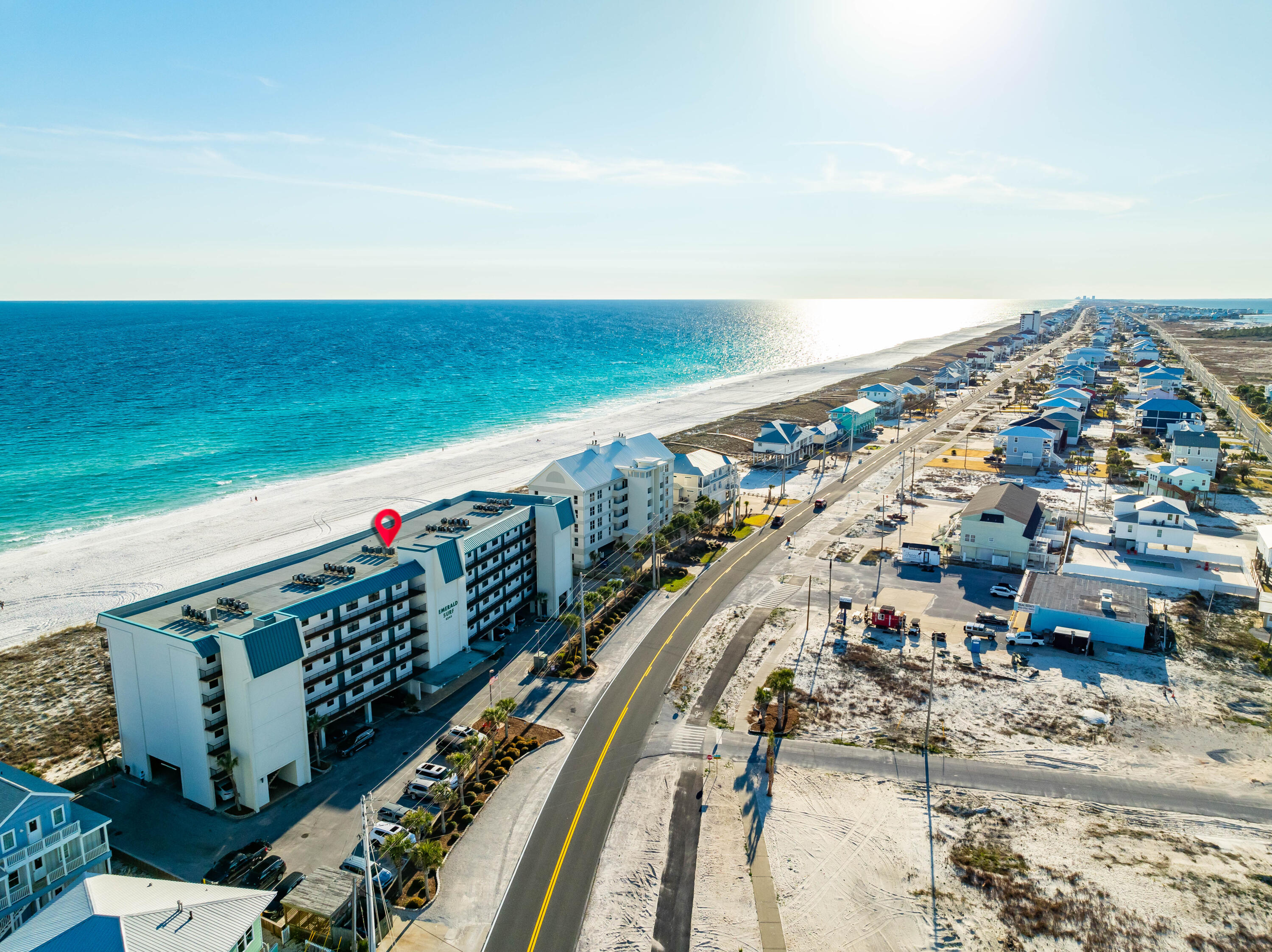 Unobstructed Gulf front views from the living room, kitchen, and dining room in this fully furnished condo, located in the center of the Emerald Surf building. Enjoy easy access to the private beach and community pool. The spacious balcony overlooks the beach with sliding glass doors providing direct access from both the living area and primary bedroom. This uniquely large floor plan is only found in a handful of select units in the building and showcases a beach inspired wall mural upon entry. Condo is equipped with a stackable washer and dryer in unit, new kitchen appliances, beach-themed wood furniture, and tile floor throughout. The guest bathroom has had a newly installed vanity. The reserved covered parking space, exclusively assigned to this unit, is located steps from the elevator Navarre Beach is one of the last areas with an "Old Florida" appeal and a Fantastic Place to Live and Own a Piece of Paradise as either Secondary/Investment or Primary Home. Navarre Beach has Miles and Miles of White Sandy, Crowd Free Beaches, and Stunning Emerald Hued Waters. There's plenty of Leisure Activities to enjoy whether on the Gulf of Mexico or the Santa Rosa Sound, with Parks, Hiking/Biking Paths, and the Spectacular Gulf Islands National Seashore. Just over the National Seashore is Pensacola Beach for even more Entertainment, Shops, and Restaurants.