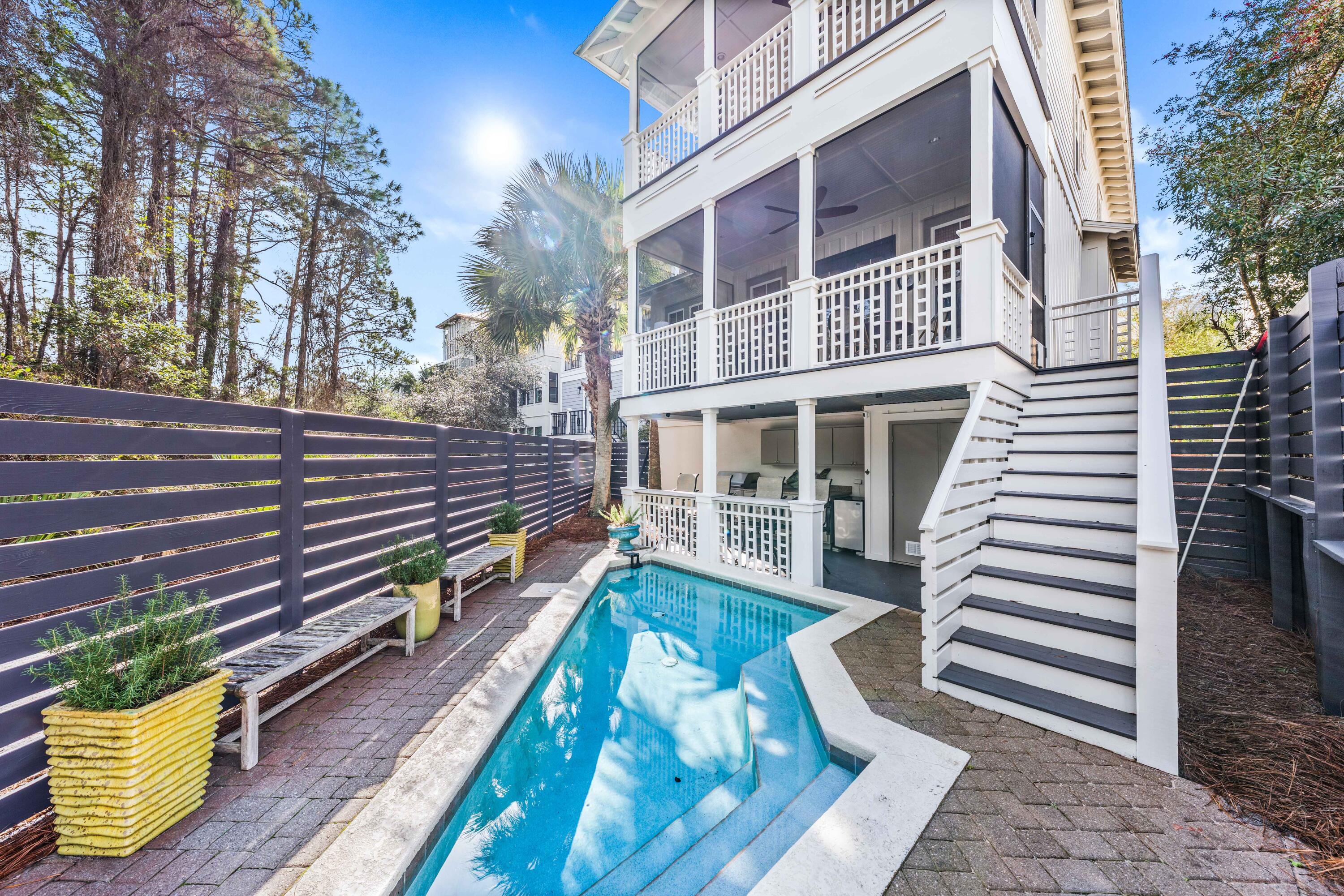 Find relaxed coastal living at this charming 4BR/4.5BA retreat with nearly 2,500 square feet of living space, multiple porches, and a private outdoor oasis complete with pool, outdoor kitchen, and bar with ample seating. Recent updates include exterior painting, new fencing around the pool and refreshed landscaping. Nestled in the popular Seacrest Beach community on 30A's coveted east end, homeowners and guests enjoy a suite of outstanding amenities including a 12,000-square-foot lagoon-style resort pool, nature trails, deeded beach access, and shuttle service directly to the beach. Step inside to discover an impeccably designed interior where custom finishes, curated details, and effortless style create an ambiance of understated luxury. The open-concept living area, complete with a sleek wet bar, flows seamlessly to outdoor spaces perfect for hosting or unwinding. The chef-inspired kitchen features a striking center island, high-end appliances, and abundant custom cabinetry with a separate pantry.
Each of the four spacious bedrooms offers a private retreat, complete with an ensuite bath for ultimate convenience. The first-floor primary suite is a sanctuary of comfort, boasting a private porch, a walk-in closet, and a spa-like ensuite with a soaking tub and separate shower. Upstairs, two elegantly appointed king suites provide luxurious accommodations, while the bunk room with six built-in beds presents the perfect setup for family and guests.
This one-owner home has been meticulously maintained and offers a rare combination of privacy, location, and resort-style amenities. Whether you're seeking a luxurious second home or a high-performing investment property, this residence is a rare gem along 30A.
