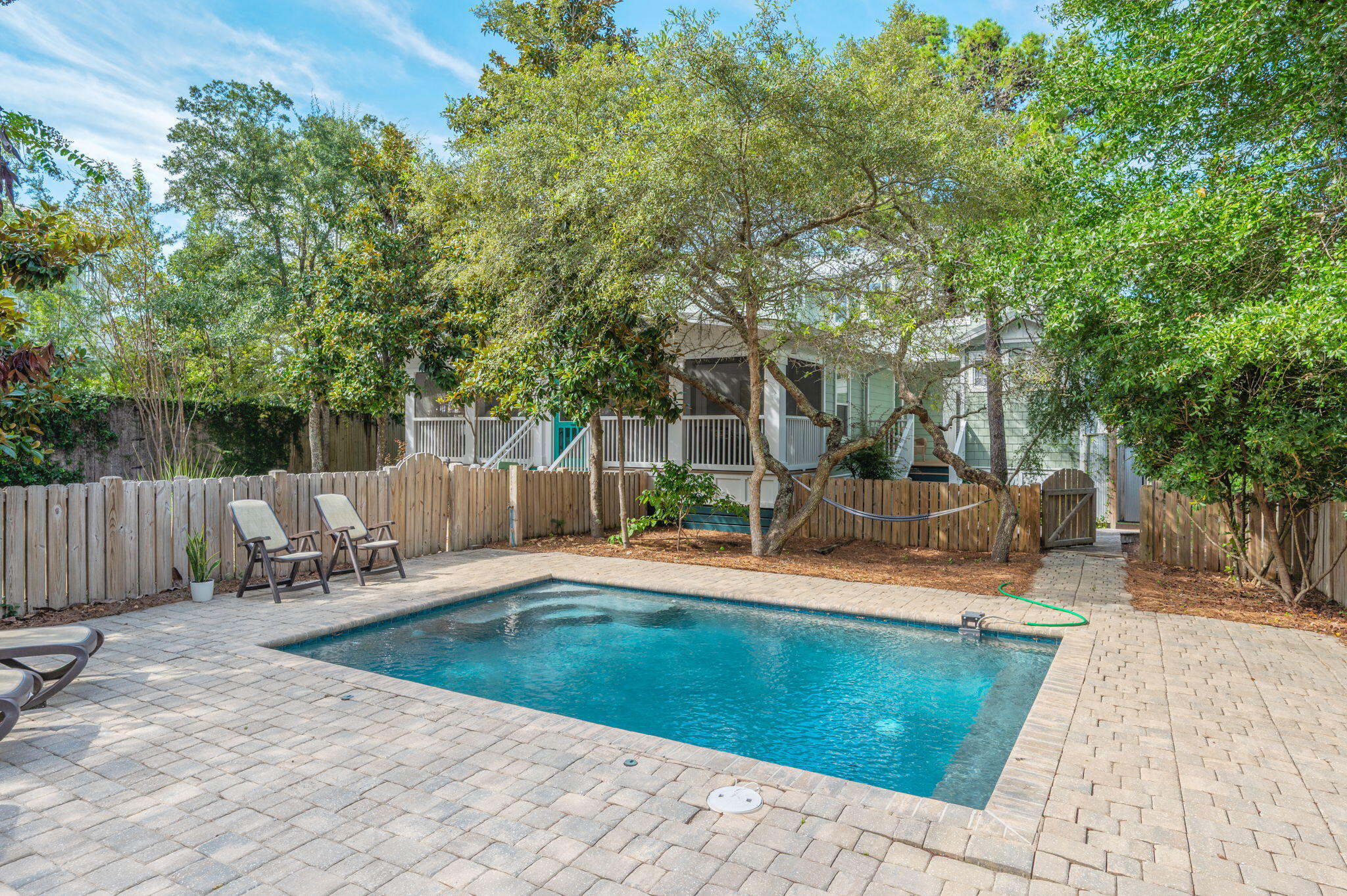 ''Close Enough'' is located in Seagrove Beach literally minutes from Seaside's Town Center where dining, shopping, and entertainment await, and only 2 blocks from the Dogwood/Thyme Street beach access. This adorable home started as a 1 bedroom 1 bath with only 864 sq-ft. Maintaining its Old Seagrove' charm, the home was completely renovated in 2010 and boasts a large screened front porch, 2 first floor master suites each with private entrance, deck, and outdoor shower; a third ensuite guest room and a spacious loft with twin beds and a second living area on the second floor. For outdoor enthusiasts, enjoy dining on the grill deck, unwind by the large heated pool, or relax in the hammock under the trees. When it's time to go to the beach, all your gear is in the ample storage building and  golf cart awaits in the separate garage to explore all of 30A. "Close Enough" sits back from the street allowing privacy and enjoyment of the natural landscape. This compound-like property's oversize lot provides abundant parking and the option to add a carriage house, enhancing its appeal and potential.