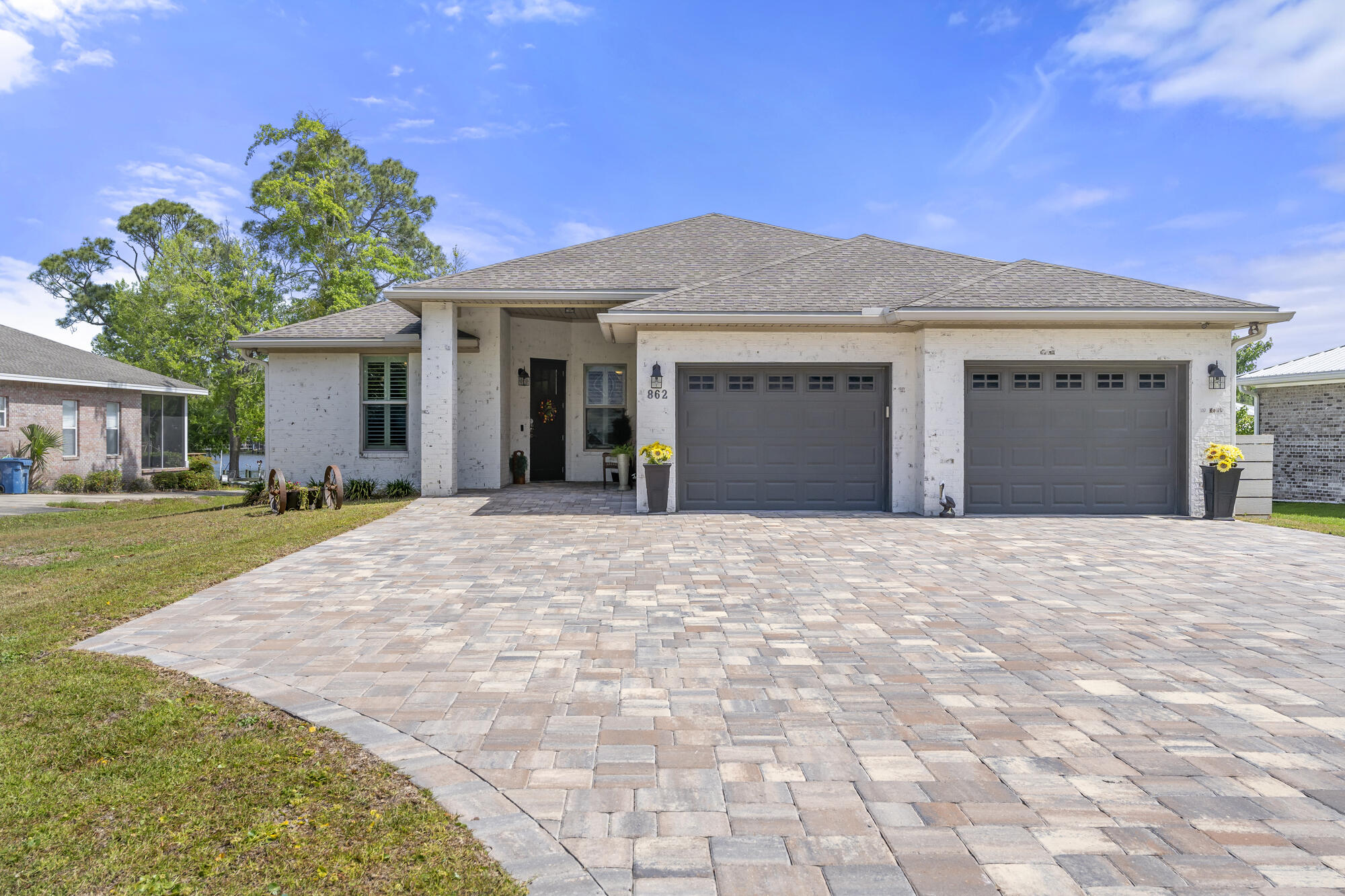 This stunning 2015 built, FURNISHED Bayfront home, with 2164 Sq. Ft., is a true masterpiece! With 81 feet of direct access, this single-level Brick residence offers great views, 4 bedrooms, 2.5 bathrooms, a private office, Pool, Hot tub & MORE!
The property features a private dock, covered boat lift & deep- water access. You'll love the expansive swimming pool with a tanning shelf. Unwind in the 6-person hot tub, watch the outdoor TV, or hang out under the large covered porch in the bed swing.
The outdoor kitchen is a dream! It includes a Green Egg, large griddle, beverage fridge, ice machine, bar stools, & granite countertops. There's also a built-in firepit with Adirondack chairs.
Inside, the chef's kitchen is outfitted with stainless steel appliances, ample cabinet & counter space, you will find beautiful furniture, great layout and a chef's kitchen featuring a walk in panty, ample cabinets and counterspace to entertain.  The dedicated office includes a beautiful high end desk, credenza, chairs and windows to provide plenty of light.
A Fenced yard, large Paver Driveway, and Oversized Garage with built-in cabinetry offer both beauty and practicality. The spacious Attic provides easy-access storage where you can even stand upright. Did I mention this (NON HOA) neighborhood is located by shopping, restaurants, Publix and minutes to Santa Rosa Beach.
Engineered for unmatched Storm Protection, this home is built like a Fortress. All windows are Hurricane-Impact; French doors are rated to 145 mph; and Outward-opening Exterior doors add an Extra layer of Security. The brick exterior features closely spaced wall ties bolted to footings, Trusses secured with Hurricane straps, and Garage doors rated to 200 mph. A rubberized, glued-down Roofing Underlayment ensures Protection even if shingles are compromised.
From its Beautiful Views and Luxury Finishes to its Exceptional Safety features and unparalleled Outdoor Amenities, this bayfront home offers the perfect blend of comfort, craftsmanship, and coastal living. Don't miss this extraordinary opportunity!