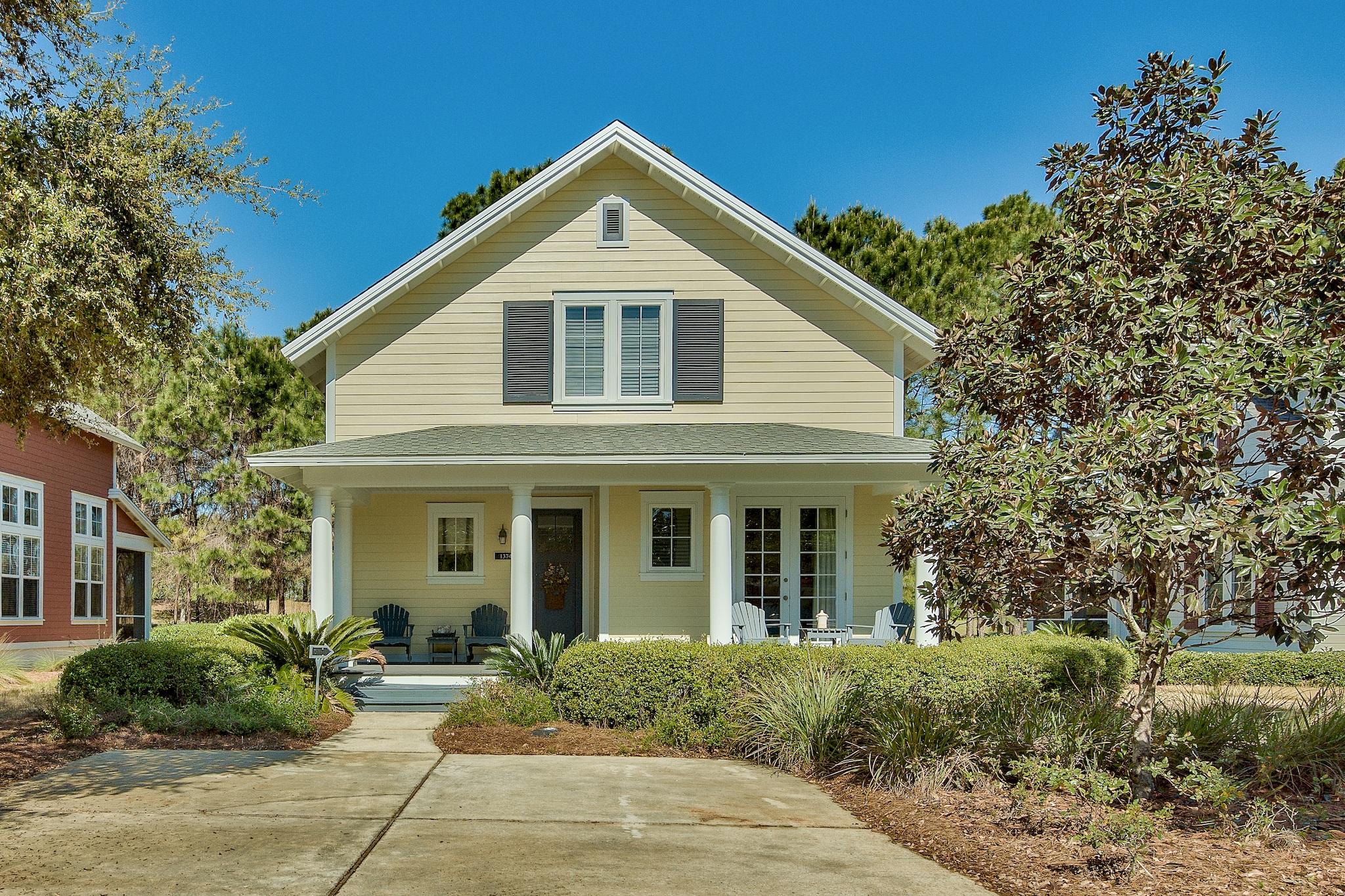Welcome to this charming Florida cottage in the quaint neighborhood of Laurel Grove. Enjoy the large open front and back porches, great for relaxing or entertaining and enjoying the rear golf course view. The first level offers an open living and dining area with plenty of room for the whole family, and a fully equipped kitchen with stainless steel appliances, custom cabinetry, and granite counter tops. The spacious downstairs master bedroom has french doors leading to the front porch and an en suite bath with double vanity, garden tub, and walk-in shower. Also on the first level is a powder room and large storage closet. On the second level you will find three further bedrooms, two with adjoining full baths and incredibly large walk-in closets.