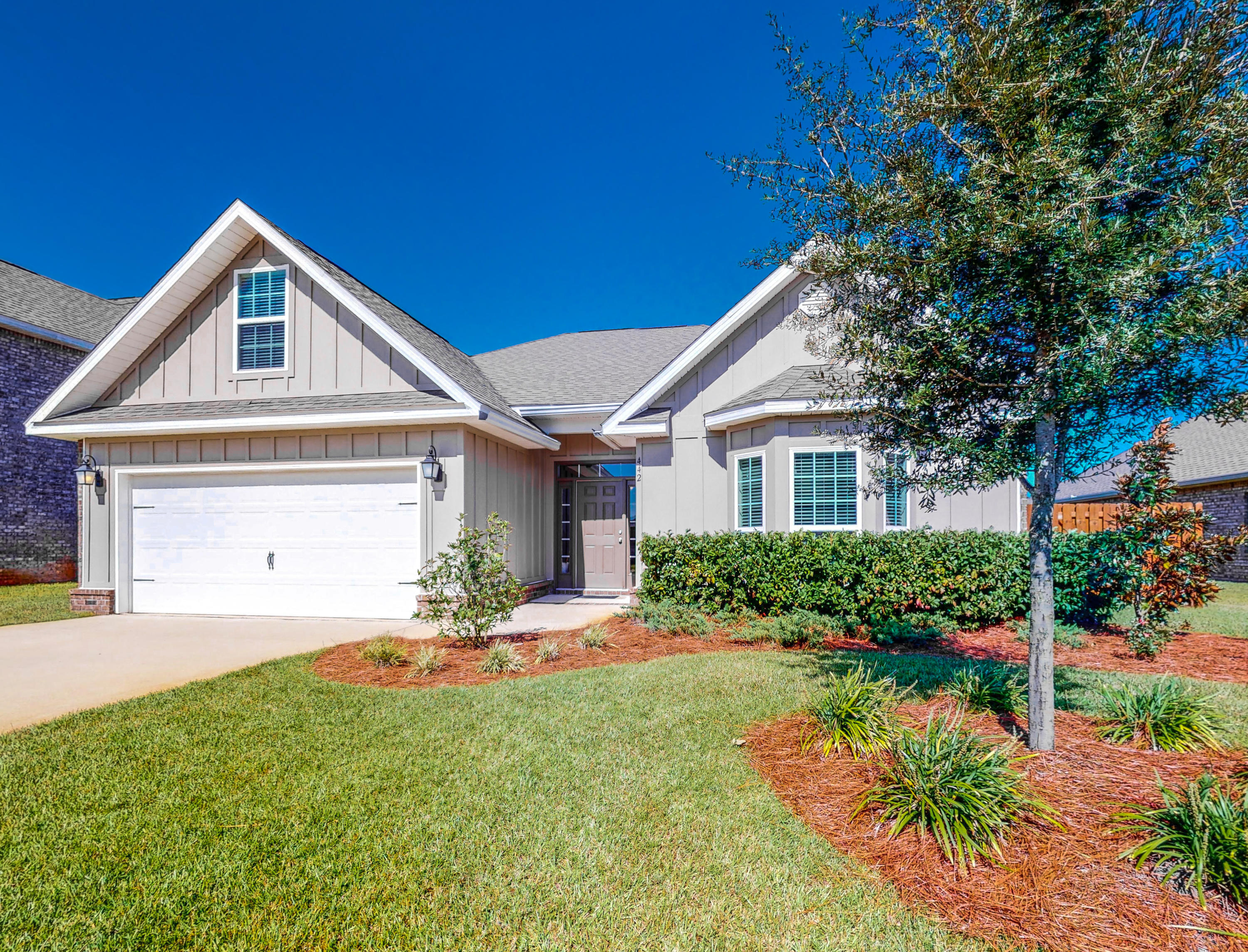 This gorgeous 2 year old home is just across the street from one of Hammock Bay's many parks. The expansive master bedroom with it's tray ceiling, has a large sitting area and beautiful spa like bath with a tile shower and granite countertops. In addition to the two other bedrooms, there is a flex room over the garage with it's own closet and access to a large storage area. The living room also features a tray ceiling and opens to the chef's kitchen and dining area. The newly added backsplash sparkles as do the stainless appliances, brushed nickel fixtures, and granite countertops. The dining area adjoins the large Florida room with it's views out to the back patio and the huge fully fenced and irrigated backyard. Plenty of room for an outdoor kitchen, pool, spa, gardens or all the above! The Florida Room also accesses the Master bedroom. The entire home is painted in a light bright grey with white trim, extensive crown molding and hardwood floors in all the common areas of the home. The paint and flooring reflects the best in current decorating trends! 3 sides of the home are brick clad, and the home has it's own private well and irrigation system for the entire lot. The backyard is privacy fenced with oversize gates for access. There is a gas stub for the grill and stove while the current stove is electric,and the water heater is gas. This is a gorgeous, impeccably maintained home in Hammock Bay's Central Park neighborhood. Hammock Bay is an unparalleled development with hiking trails, ponds, woods and spectacular amenities. Walton County is the 6th fastest growing county in the US and the fastest growing county in Florida. This is the time to chart your future in this wonderful home!