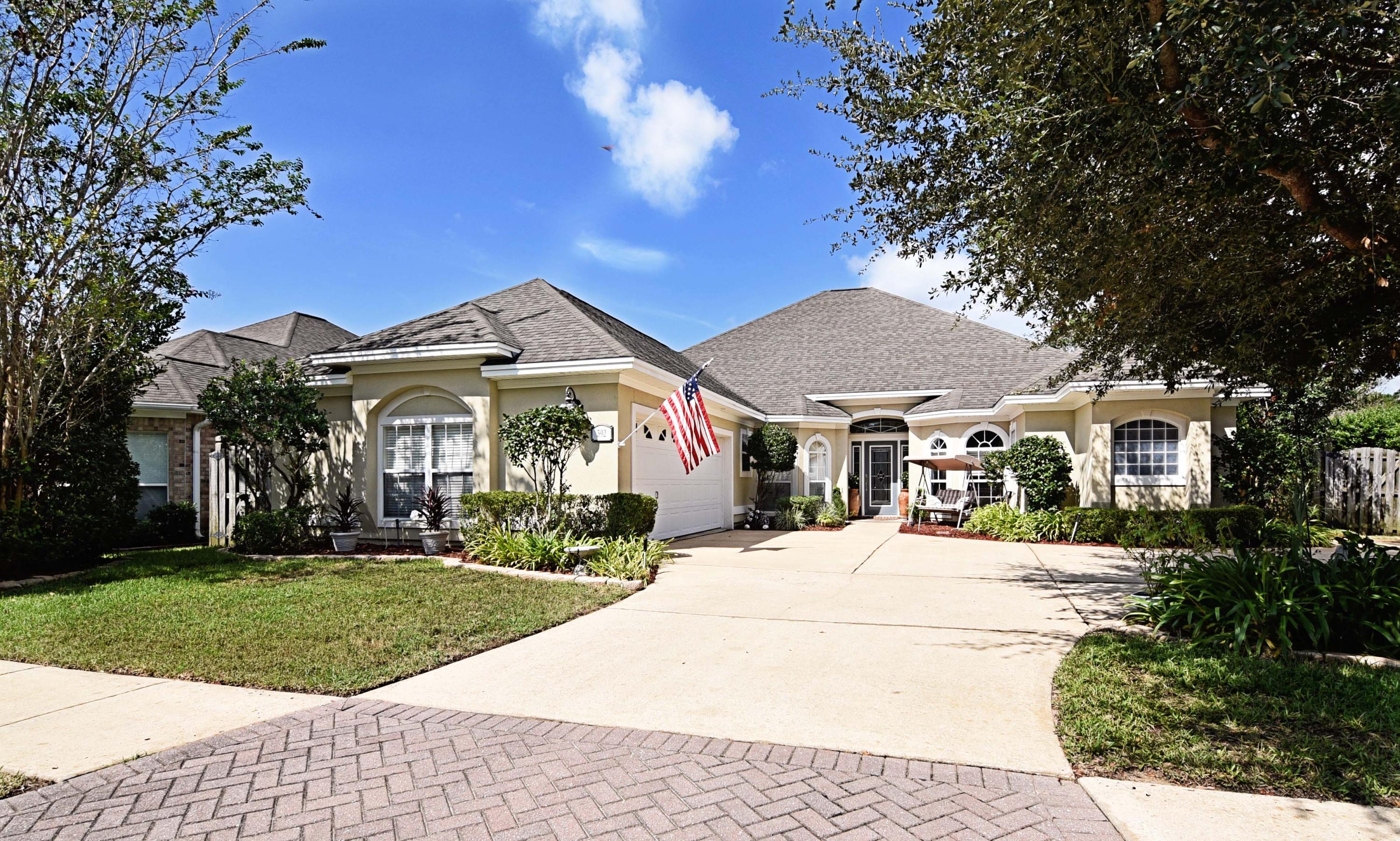 ABSOLUTELY STUNNING! This home is in move in condition and is beautiful. CUSTOM built,the attention to detail shows in features both small and large. The exterior features lush colorful landscaping around the circular driveway, adding to the pleasing curb appeal.The interior has been freshly painted and is open and airy. Gleaming HARDWOOD floors lend an elegant air to a very family friendly floor plan with the large family room and fireplace in the center of the home.To one side, you find the OFFICE and master bedroom suite. The bedroom is large and the bathroom area is gorgeous, with a large walk in shower featuring 2 shower heads and lovely tile along with a tub and double vanity. The other side of the home holds the other 3 bedrooms,plus a DEN that is currently being used as a nursery. The kitchen is large and perfect for a serious cook. Lots of GRANITE counter tops offset the handsome maple cabinets and STAINLESS steel appliances. A large laundry room makes chores easier and is handy next to the additional bedrooms. The backyard, however, is enough reason to buy this home! You literally feel like you are in the ITALIAN COUNTRYSIDE, with the beautiful paver patio and quaint feel of the the area. A pergola, tinkling fountain, and the privacy provided by the divine landscaping will make you want to stay here all day, reading or entertaining family and friends with al fresco meals. It was 20 degrees cooler back there during a recent visit, which is perfect for the kids or dogs to play in the large grassy side yard in the back. This home offers many more upgrades, too numerous to mention, plus it is close to bases, shopping, restaurants and beaches. Please call today to see it before it sells. You will be glad you did!