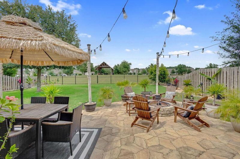 Charming 3-bedroom, 2-bath home with backyard paradise in Hammock Bay! This property features numerous kitchen upgrades and LVP floors throughout! Step outside to enjoy your private oasis with a custom paver patio including a built-in fire pit and beautifully fenced yard with tropical plants and banana trees. Tired of neighbors in your back yard? Your private yard abuts a dedicated green space with a professionally designed community pavilion. Conveniently located within walking distance to an 8,000 SF 24/7 fitness center, three swimming pools, general store, brewery, Lake Club, and all the entertainment Hammock Bay offers. Best of all? You're just 20 minutes from the world-famous white sugar sand beaches of 30A. Come see your new home at 54 Mary Ellen Way!