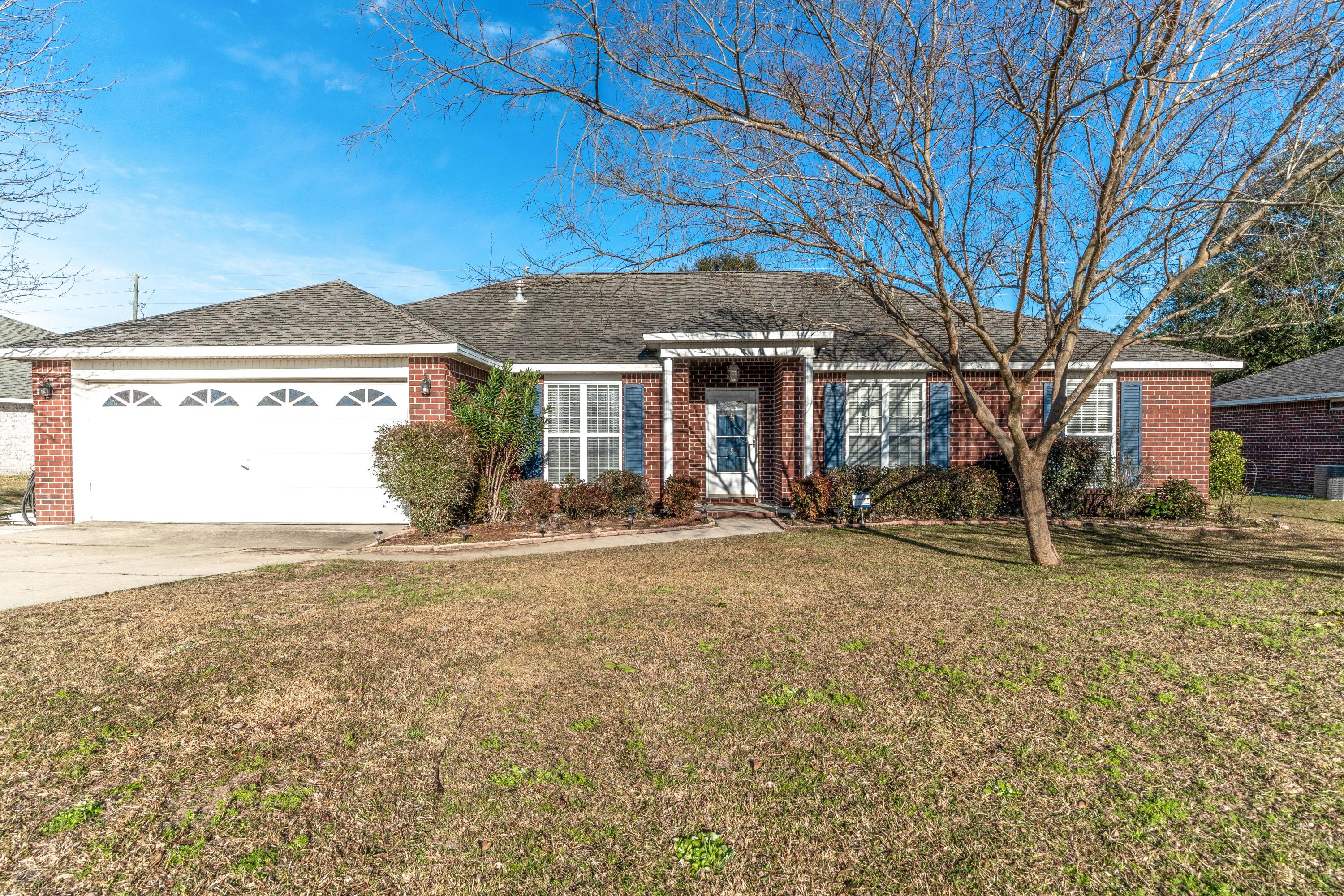 This beautiful home in South Crestview isn't just conveniently located near beaches, shopping, and the military installations, it offers so much more! Inside you will be delighted to see the wood laminate flooring flowing through the majority of the home, wainscoting in the oversized dining/flex room, and a gas fireplace in the centrally located family room. The bedrooms are split, offering a private retreat to the master bedroom where you will find a large ensuite bathroom with dual vanity, garden tub, separate shower, and a large walk-in closet. The master bedroom and a guest room are also both hardwired for internet. Out back, you will notice the spacious, screened in back porch overlooking the flat backyard making outdoor entertaining a breeze.